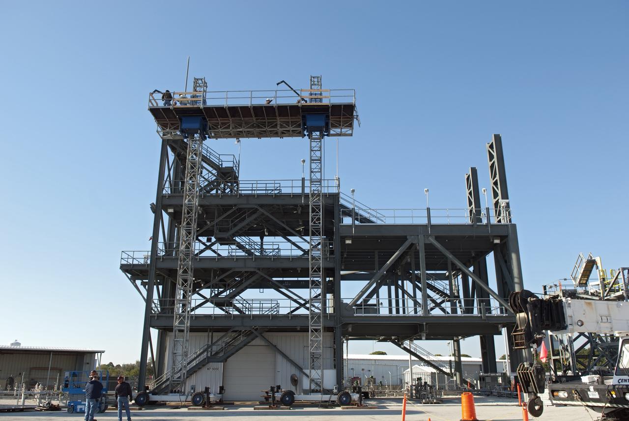 CAPE CANAVERAL, Fla. -- At NASA's Kennedy Space Center in Florida, workers receive training atop a mast climber that is attached to launch simulation towers outside the Launch Equipment Test Facility. The training includes attaching carrier plates, water and air systems, and electricity to the climber to simulate working in Kennedy's Vehicle Assembly Building (VAB). Mast climbers can be substituted for fixed service structures currently inside the VAB to provide access to any type of launch vehicle.     Since 1977, the facility has supported NASA’s Launch Services, shuttle, International Space Station, and Constellation programs, as well as commercial providers. Last year, the facility underwent a major upgrade to support even more programs, projects and customers. It houses a 6,000-square-foot high bay, cable fabrication and molding shop, pneumatics shop, machine and weld shop and full-scale control room. Outside, the facility features a water flow test loop, vehicle motion simulator and a cryogenic system. Photo credit: NASA/Jim Grossmann