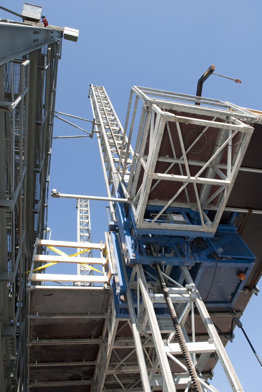 CAPE CANAVERAL, Fla. -- At NASA's Kennedy Space Center in Florida, training takes place atop a mast climber that is attached to launch simulation towers outside the Launch Equipment Test Facility. The training includes attaching carrier plates, water and air systems, and electricity to the climber to simulate working in Kennedy's Vehicle Assembly Building (VAB). Mast climbers can be substituted for fixed service structures currently inside the VAB to provide access to any type of launch vehicle.      Since 1977, the facility has supported NASA’s Launch Services, shuttle, International Space Station, and Constellation programs, as well as commercial providers. Last year, the facility underwent a major upgrade to support even more programs, projects and customers. It houses a 6,000-square-foot high bay, cable fabrication and molding shop, pneumatics shop, machine and weld shop and full-scale control room. Outside, the facility features a water flow test loop, vehicle motion simulator and a cryogenic system. Photo credit: NASA/Jim Grossmann