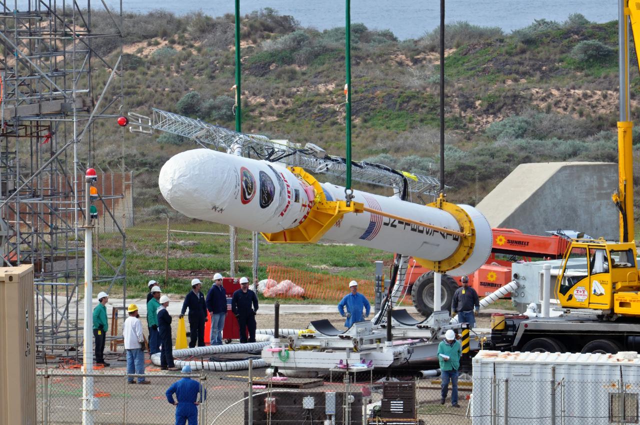 VANDENBERG AIR FORCE BASE, Calif. -- On Space Launch Complex 576-E at Vandenberg Air Force Base in California, Orbital Sciences workers monitor NASA's Glory upper stack as a crane lifts it from a stationary rail for attachment to the Taurus XL rocket's Stage 0. The upper stack consists of Stages 1, 2 and 3 of the Taurus as well as the encapsulated Glory spacecraft. Workers put the non-flight environmental shield over the fairing prior to assembly. A portion of the umbilical tower is attached to the upper stack which falls away from the spacecraft during liftoff.          The Orbital Sciences Taurus XL rocket will launch Glory into low Earth orbit. Once Glory reaches orbit, it will collect data on the properties of aerosols and black carbon. It also will help scientists understand how the sun's irradiance affects Earth's climate. Launch is scheduled for 5:09 a.m. EST Feb. 23. For information, visit www.nasa.gov/glory. Photo credit: NASA/Randy Beaudoin, VAFB