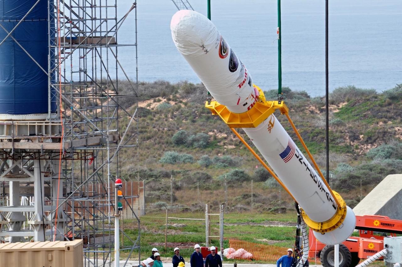 VANDENBERG AIR FORCE BASE, Calif. -- On Space Launch Complex 576-E at Vandenberg Air Force Base in California, Orbital Sciences workers monitor NASA's Glory upper stack as a crane lifts it from a stationary rail for attachment to the Taurus XL rocket's Stage 0. The upper stack consists of Stages 1, 2 and 3 of the Taurus as well as the encapsulated Glory spacecraft. Workers put the non-flight environmental shield over the fairing prior to assembly. The Orbital Sciences Taurus XL rocket will launch Glory into low Earth orbit. Once Glory reaches orbit, it will collect data on the properties of aerosols and black carbon. It also will help scientists understand how the sun's irradiance affects Earth's climate. Launch is scheduled for 5:09 a.m. EST Feb. 23. For information, visit www.nasa.gov/glory. Photo credit: NASA/Randy Beaudoin, VAFB