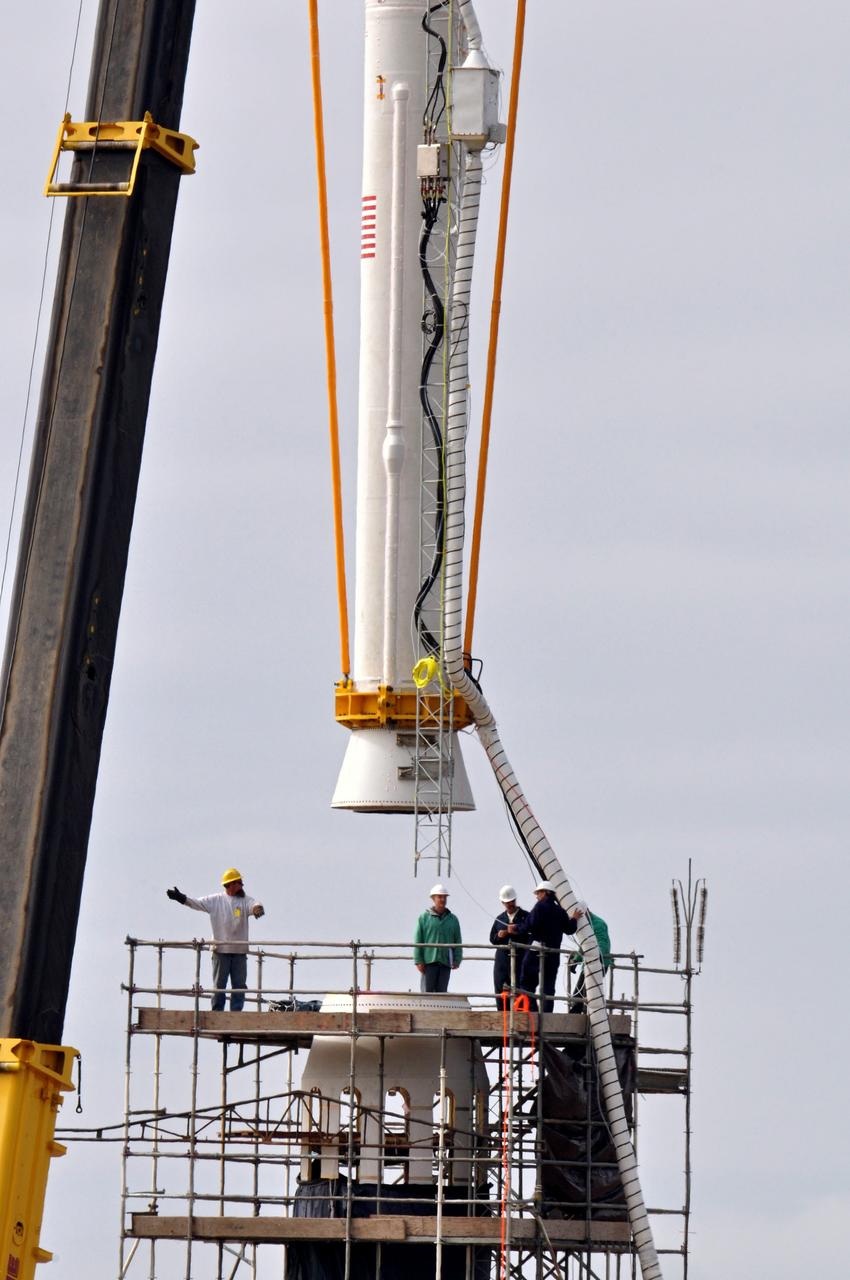 VANDENBERG AIR FORCE BASE, Calif. -- On Space Launch Complex 576-E at Vandenberg Air Force Base in California, workers guide NASA's Glory upper stack as a crane lowers it toward the Taurus XL rocket's Stage 0. The upper stack consists of Stages 1, 2 and 3 of the Taurus as well as the encapsulated Glory spacecraft.         The Orbital Sciences Taurus XL rocket will launch Glory into low Earth orbit. Once Glory reaches orbit, it will collect data on the properties of aerosols and black carbon. It also will help scientists understand how the sun's irradiance affects Earth's climate. Launch is scheduled for 5:09 a.m. EST Feb. 23. For information, visit www.nasa.gov/glory. Photo credit: NASA/Randy Beaudoin, VAFB