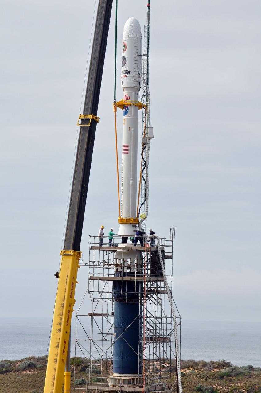 VANDENBERG AIR FORCE BASE, Calif. -- On Space Launch Complex 576-E at Vandenberg Air Force Base in California, workers guide NASA's Glory upper stack as a crane lowers it toward the Taurus XL rocket's Stage 0. The upper stack consists of Stages 1, 2 and 3 of the Taurus as well as the encapsulated Glory spacecraft.         The Orbital Sciences Taurus XL rocket will launch Glory into low Earth orbit. Once Glory reaches orbit, it will collect data on the properties of aerosols and black carbon. It also will help scientists understand how the sun's irradiance affects Earth's climate. Launch is scheduled for 5:09 a.m. EST Feb. 23. For information, visit www.nasa.gov/glory. Photo credit: NASA/Randy Beaudoin, VAFB