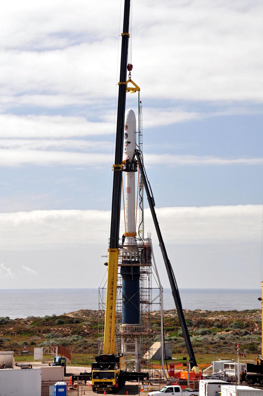 VANDENBERG AIR FORCE BASE, Calif. -- On Space Launch Complex 576-E at Vandenberg Air Force Base in California, workers in a bucket begin the process of removing the lifting fixture and sling from NASA's Glory upper stack after it was secured in place to the Taurus XL rocket's Stage 0. The upper stack consists of Stages 1, 2 and 3 of the Taurus as well as the encapsulated Glory spacecraft.         The Orbital Sciences Taurus XL rocket will launch Glory into low Earth orbit. Once Glory reaches orbit, it will collect data on the properties of aerosols and black carbon. It also will help scientists understand how the sun's irradiance affects Earth's climate. Launch is scheduled for 5:09 a.m. EST Feb. 23. For information, visit www.nasa.gov/glory. Photo credit: NASA/Randy Beaudoin, VAFB