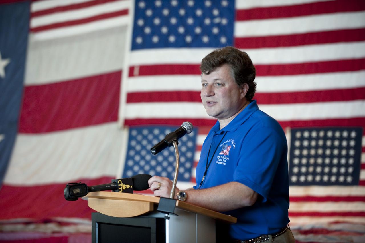 CAPE CANAVERAL, Fla. -- In the Debus Conference Facility at the Kennedy Space Center Visitor Complex in Florida, Jeff Parness, the director, founder and chairman of the "New York Says Thank You Foundation" talks about the work and devotion that has gone into restoring "The National 9/11 Flag." The contributions of NASA, Kennedy Space Center and the state of Florida were stitched into the fabric of the American Flag, which was recovered near ground zero following the World Trade Center attacks on Sept. 11, 2001.       The "New York Says Thank You Foundation" is taking the flag on a cross-country journey to be restored to its original 13-stripe design using pieces of fabric from American flags destined for retirement in all 50 states. Once the flag is restored, it will become a permanent collection of the National September 11 Memorial Museum being built at the World Trade Center site. Photo credit: NASA/Kim Shiflett