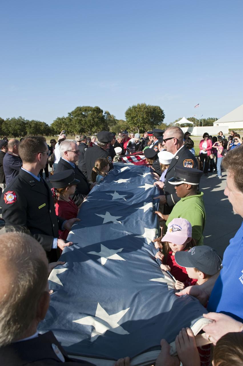 CAPE CANAVERAL, Fla. -- "The National 9/11 Flag" is folded in the Rocket Garden at the Kennedy Space Center Visitor Complex in Florida. The contributions of NASA, Kennedy Space Center and the state of Florida were stitched into the fabric of the American Flag, which was recovered near ground zero following the World Trade Center attacks on Sept. 11, 2001.     The "New York Says Thank You Foundation" is taking the flag on a cross-country journey to be restored to its original 13-stripe design using pieces of fabric from American flags destined for retirement in all 50 states. Once the flag is restored, it will become a permanent collection of the National September 11 Memorial Museum being built at the World Trade Center site. Photo credit: NASA/Kim Shiflett
