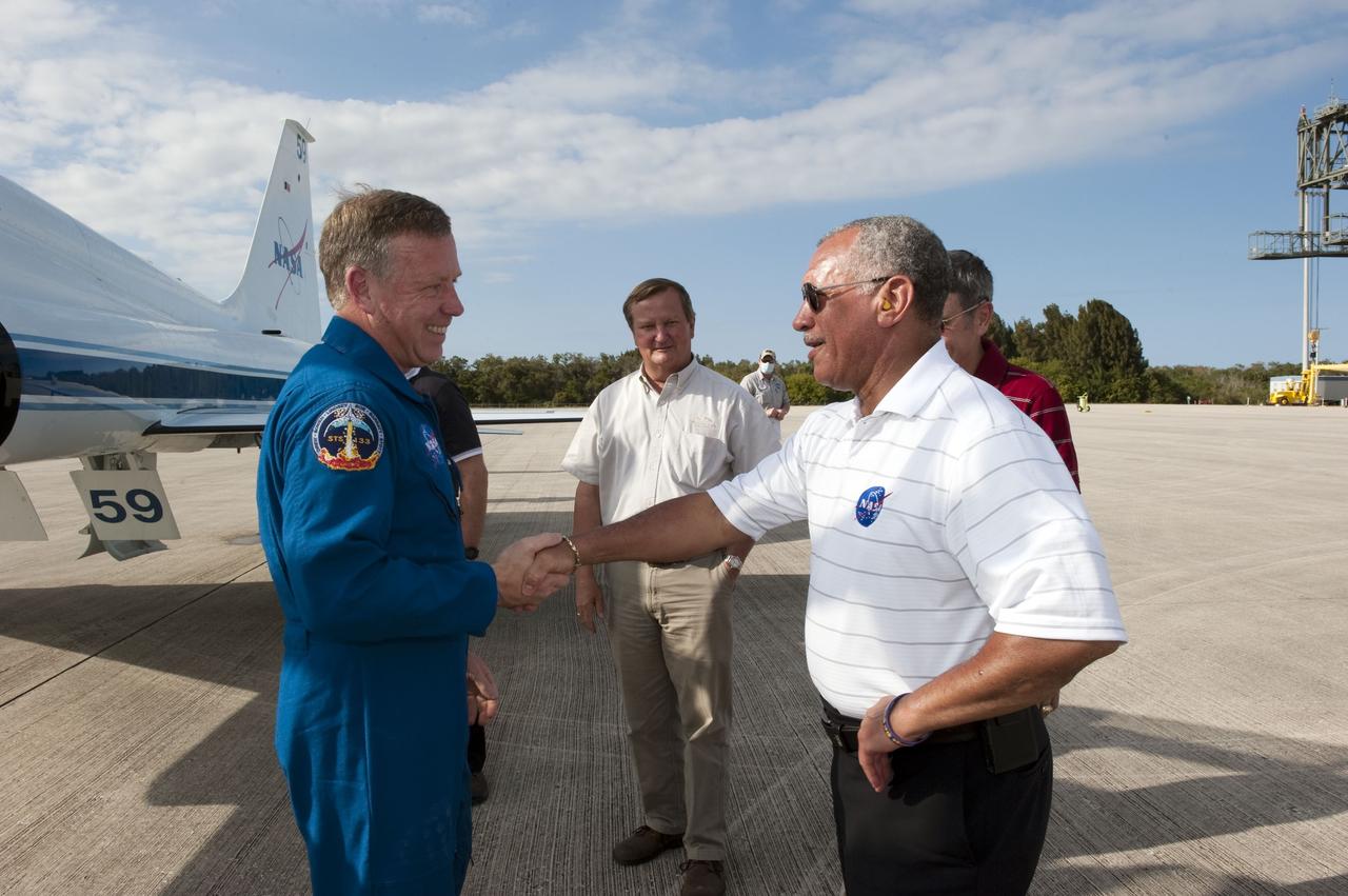 CAPE CANAVERAL, Fla. -- At NASA's Kennedy Space Center in Florida, space shuttle Discovery's STS-133 Commander Steve Lindsey greets NASA Administrator Charlie Bolden on the Shuttle Landing Facility runway after arriving aboard a T-38 jet. Also on hand to greet the crew were Jerry Ross, chief of the Vehicle Integration Test Office, Mike Leinbach, shuttle launch director, center, and Kennedy Center Director Bob Cabana. In the days leading up to their launch to the International Space Station, Lindsey and his crew members will check the fit of their launch-and-entry suits, review launch-day procedures, receive weather briefings and remain medically quarantined to prevent sickness. This will be the second launch attempt for Discovery's crew, following a scrub in November 2010 due to a hydrogen gas leak at the ground umbilical carrier plate (GUCP) as well as modifications to the external fuel tank's intertank support beams, called stringers.          Scheduled to lift off Feb. 24 at 4:50 p.m. EST, Discovery and its crew will deliver the Permanent Multipurpose Module, packed with supplies and critical spare parts, as well as Robonaut 2, the dexterous humanoid astronaut helper, to the orbiting outpost. For more information on the STS-133 mission, visit www.nasa.gov/mission_pages/shuttle/shuttlemissions/sts133/.  Photo credit: NASA/Kim Shiflett