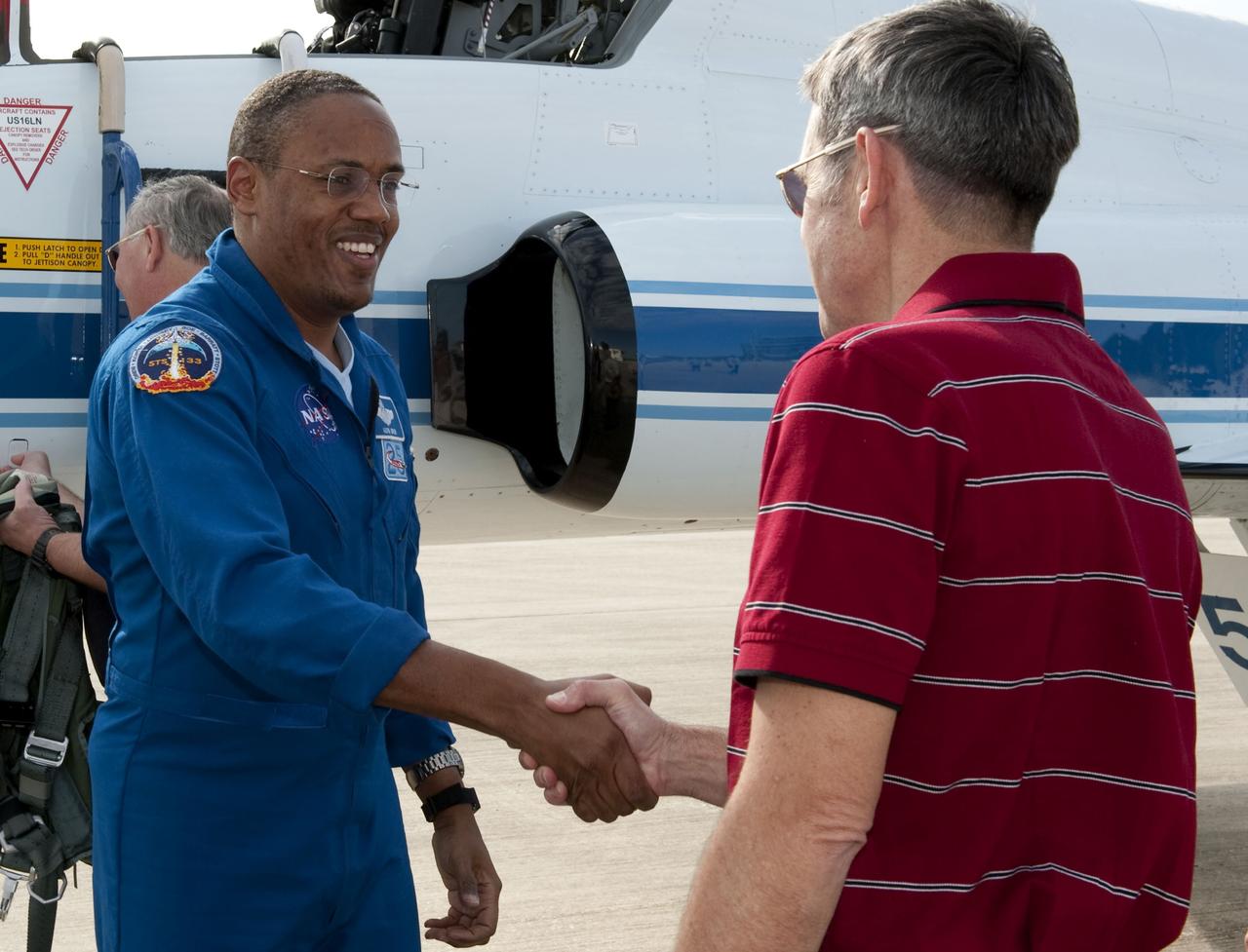 CAPE CANAVERAL, Fla. -- At NASA's Kennedy Space Center in Florida, space shuttle Discovery's STS-133 Mission Specialist Alvin Drew greets Kennedy Center Director Bob Cabana on the Shuttle Landing Facility runway after arriving aboard a T-38 jet. In the days leading up to their launch to the International Space Station, Drew and his crew members will check the fit of their launch-and-entry suits, review launch-day procedures, receive weather briefings and remain medically quarantined to prevent sickness. This will be the second launch attempt for Discovery's crew, following a scrub in November 2010 due to a hydrogen gas leak at the ground umbilical carrier plate (GUCP) as well as modifications to the external fuel tank's intertank support beams, called stringers. Scheduled to lift off Feb. 24 at 4:50 p.m. EST, Discovery and its crew will deliver the Permanent Multipurpose Module, packed with supplies and critical spare parts, as well as Robonaut 2, the dexterous humanoid astronaut helper, to the orbiting outpost. For more information on the STS-133 mission, visit www.nasa.gov/mission_pages/shuttle/shuttlemissions/sts133/. Photo credit: NASA/Kim Shiflett