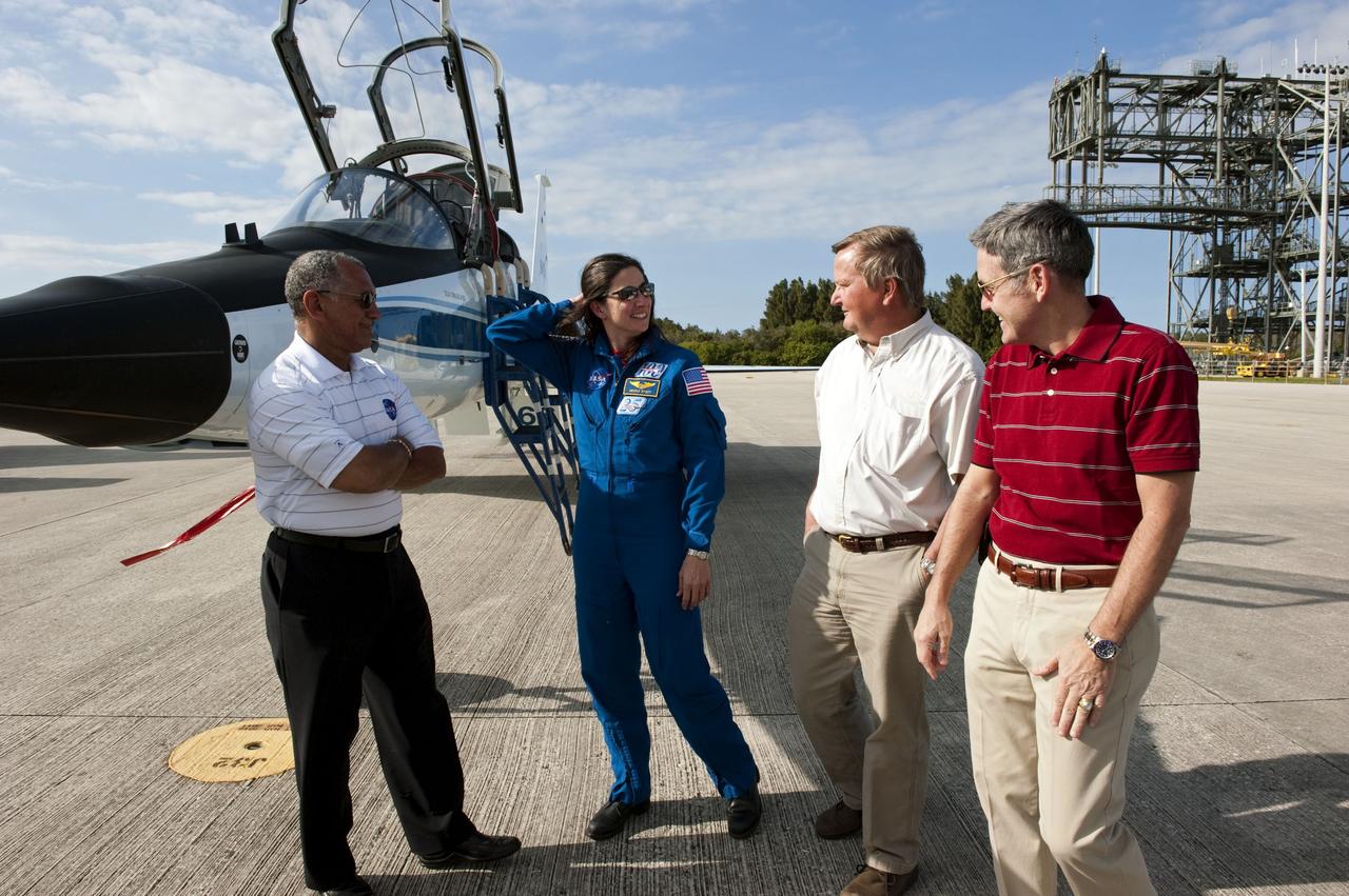 CAPE CANAVERAL, Fla. -- At NASA's Kennedy Space Center in Florida, NASA Administrator Charlie Bolden, left, space shuttle Discovery's STS-133 Mission Specialist Nicole Stott, Shuttle Launch Director Mike Leinbach and Kennedy Center Director Bob Cabana chat on the Shuttle Landing Facility runway. In the days leading up to their launch to the International Space Station, Stott and her crew members will check the fit of their launch-and-entry suits, review launch-day procedures, receive weather briefings and remain medically quarantined to prevent sickness. This will be the second launch attempt for Discovery's crew, following a scrub in November 2010 due to a hydrogen gas leak at the ground umbilical carrier plate (GUCP) as well as modifications to the external fuel tank's intertank support beams, called stringers. Scheduled to lift off Feb. 24 at 4:50 p.m. EST, Discovery and its crew will deliver the Permanent Multipurpose Module, packed with supplies and critical spare parts, as well as Robonaut 2, the dexterous humanoid astronaut helper, to the orbiting outpost. For more information on the STS-133 mission, visit www.nasa.gov/mission_pages/shuttle/shuttlemissions/sts133/. Photo credit: NASA/Kim Shiflett