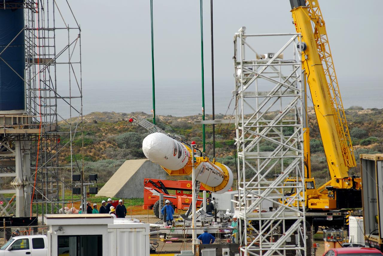 VANDENBERG AIR FORCE BASE, Calif. -- On Space Launch Complex 576-E at Vandenberg Air Force Base in California, Orbital Sciences workers monitor NASA's Glory upper stack as a crane lifts it from a stationary rail for attachment to the Taurus XL rocket's Stage 0. The upper stack consists of Stages 1, 2 and 3 of the Taurus as well as the encapsulated Glory spacecraft.      The Orbital Sciences Taurus XL rocket will launch Glory into low Earth orbit. Once Glory reaches orbit, it will collect data on the properties of aerosols and black carbon. It also will help scientists understand how the sun's irradiance affects Earth's climate. Launch is scheduled for 5:09 a.m. EST Feb. 23. For information, visit www.nasa.gov/glory. Photo credit: NASA/VAFB