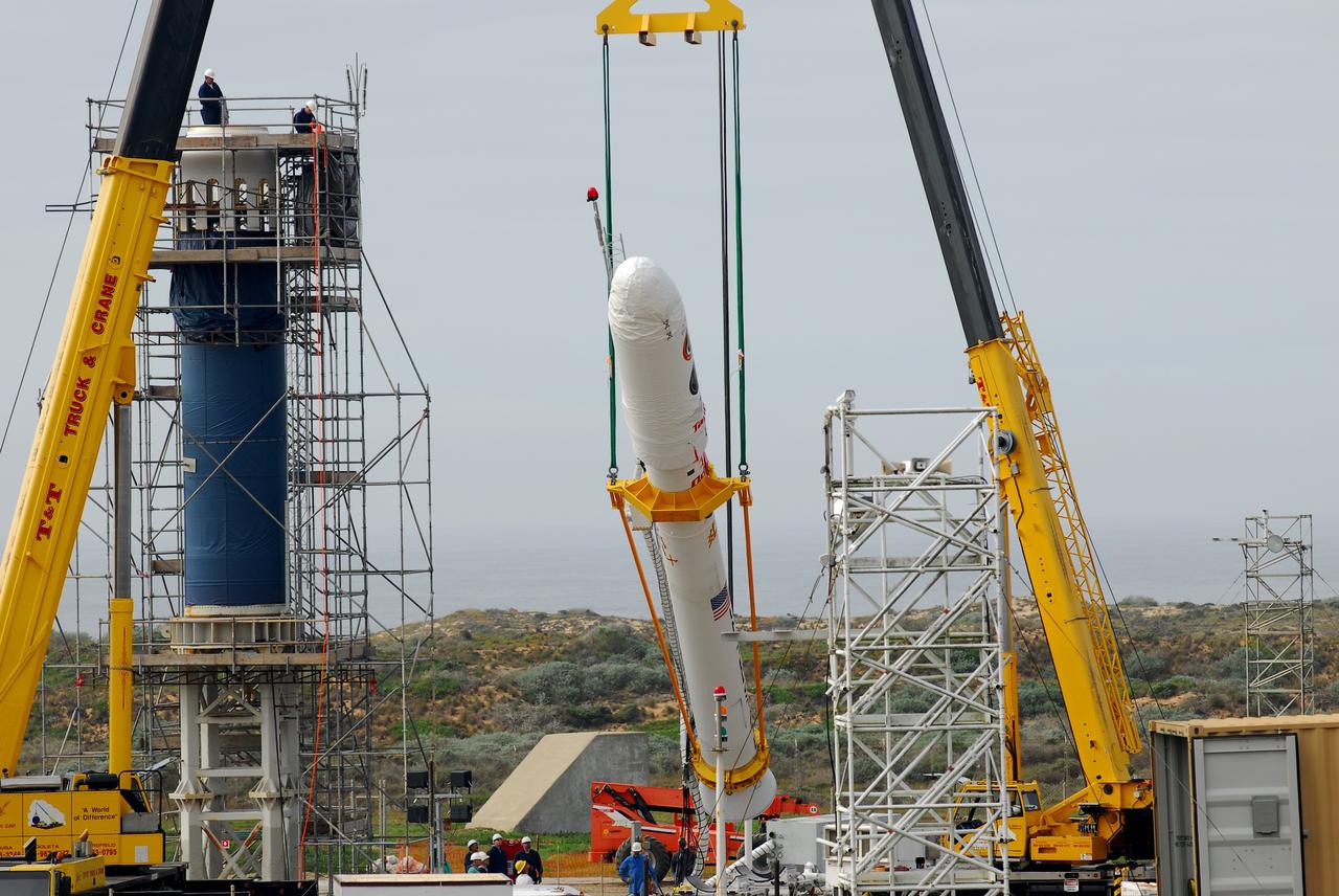 VANDENBERG AIR FORCE BASE, Calif. -- On Space Launch Complex 576-E at Vandenberg Air Force Base in California, Orbital Sciences workers monitor NASA's Glory upper stack as a crane lifts it from a stationary rail for attachment to the Taurus XL rocket's Stage 0. The upper stack consists of Stages 1, 2 and 3 of the Taurus as well as the encapsulated Glory spacecraft.     The Orbital Sciences Taurus XL rocket will launch Glory into low Earth orbit. Once Glory reaches orbit, it will collect data on the properties of aerosols and black carbon. It also will help scientists understand how the sun's irradiance affects Earth's climate. Launch is scheduled for 5:09 a.m. EST Feb. 23. For information, visit www.nasa.gov/glory. Photo credit: NASA/VAFB