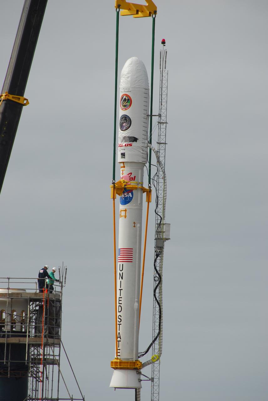 VANDENBERG AIR FORCE BASE, Calif. -- On Space Launch Complex 576-E at Vandenberg Air Force Base in California, a crane lowers NASA's Glory upper stack toward the Taurus XL rocket's Stage 0. The upper stack consists of Stages 1, 2 and 3 of the Taurus as well as the encapsulated Glory spacecraft.     The Orbital Sciences Taurus XL rocket will launch Glory into low Earth orbit. Once Glory reaches orbit, it will collect data on the properties of aerosols and black carbon. It also will help scientists understand how the sun's irradiance affects Earth's climate. Launch is scheduled for 5:09 a.m. EST Feb. 23. For information, visit www.nasa.gov/glory. Photo credit: NASA/VAFB