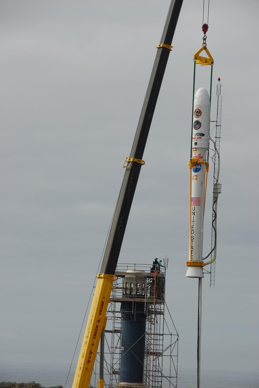 VANDENBERG AIR FORCE BASE, Calif. -- On Space Launch Complex 576-E at Vandenberg Air Force Base in California, a crane moves NASA's Glory upper stack toward the Taurus XL rocket's Stage 0. The upper stack consists of Stages 1, 2 and 3 of the Taurus as well as the encapsulated Glory spacecraft.     The Orbital Sciences Taurus XL rocket will launch Glory into low Earth orbit. Once Glory reaches orbit, it will collect data on the properties of aerosols and black carbon. It also will help scientists understand how the sun's irradiance affects Earth's climate. Launch is scheduled for 5:09 a.m. EST Feb. 23. For information, visit www.nasa.gov/glory. Photo credit: NASA/VAFB