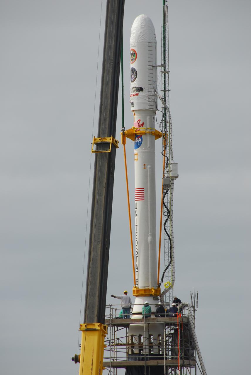 VANDENBERG AIR FORCE BASE, Calif. -- On Space Launch Complex 576-E at Vandenberg Air Force Base in California, a crane lowers NASA's Glory upper stack toward the Taurus XL rocket's Stage 0. The upper stack consists of Stages 1, 2 and 3 of the Taurus as well as the encapsulated Glory spacecraft.     The Orbital Sciences Taurus XL rocket will launch Glory into low Earth orbit. Once Glory reaches orbit, it will collect data on the properties of aerosols and black carbon. It also will help scientists understand how the sun's irradiance affects Earth's climate. Launch is scheduled for 5:09 a.m. EST Feb. 23. For information, visit www.nasa.gov/glory. Photo credit: NASA/VAFB