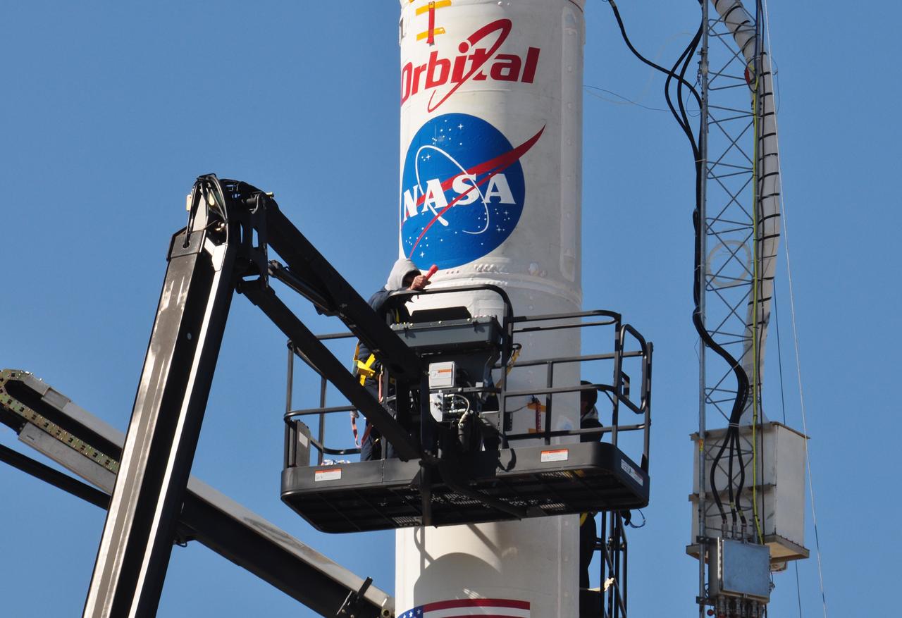 VANDENBERG AIR FORCE BASE, Calif. -- On Space Launch Complex 576-E at Vandenberg Air Force Base in California, workers in a bucket conduct closeout procedures on the Taurus XL rocket in preparations for liftoff. The umbilical tower attached to the upper stack will fall away from the spacecraft during launch.        The Orbital Sciences Taurus XL rocket will launch Glory into low Earth orbit. Once Glory reaches orbit, it will collect data on the properties of aerosols and black carbon. It also will help scientists understand how the sun's irradiance affects Earth's climate. Launch is scheduled for 5:09 a.m. EST Feb. 23. For information, visit www.nasa.gov/glory. Photo credit: NASA/Randy Beaudoin, VAFB