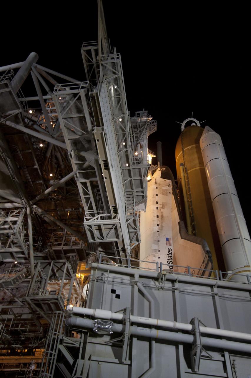 CAPE CANAVERAL, Fla. -- At NASA's Kennedy Space Center in Florida, the rotating service structure on Launch Pad 39A begins to move away from space shuttle Discovery, which is illuminated by bright xenon lights. The structure provides weather protection and access to the shuttle while it awaits lift off on the pad. RSS "rollback," as it's called, began at 8:02 p.m. EST on Feb. 23 and wrapped up at 8:37 p.m. Scheduled to lift off Feb. 24 at 4:50 p.m. EST, Discovery and its six-member crew will deliver the Permanent Multipurpose Module, packed with supplies and critical spare parts, as well as Robonaut 2, the dexterous humanoid astronaut helper, to the International Space Station. Discovery, which will fly its 39th mission, is scheduled to be retired following STS-133. This will be the 133rd Space Shuttle Program mission and the 35th shuttle voyage to the space station. For more information on the STS-133 mission, visit www.nasa.gov/mission_pages/shuttle/shuttlemissions/sts133/. Photo credit: NASA/Jack Pfaller
