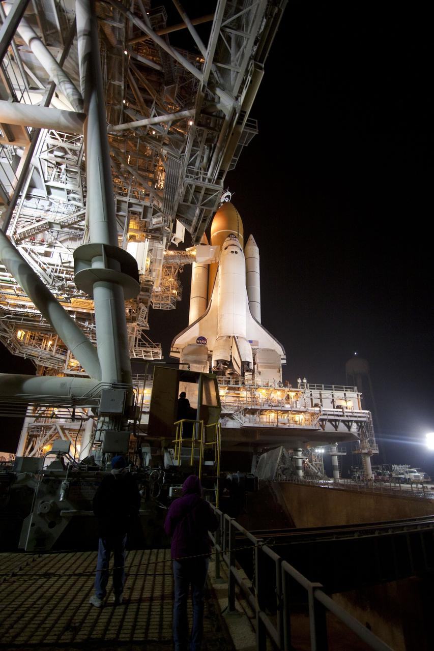 CAPE CANAVERAL, Fla. -- At NASA's Kennedy Space Center in Florida, the rotating service structure on Launch Pad 39A begins to move away from space shuttle Discovery, which is illuminated by bright xenon lights. The structure provides weather protection and access to the shuttle while it awaits lift off on the pad. RSS "rollback," as it's called, began at 8:02 p.m. EST on Feb. 23 and wrapped up at 8:37 p.m. Scheduled to lift off Feb. 24 at 4:50 p.m. EST, Discovery and its six-member crew will deliver the Permanent Multipurpose Module, packed with supplies and critical spare parts, as well as Robonaut 2, the dexterous humanoid astronaut helper, to the International Space Station. Discovery, which will fly its 39th mission, is scheduled to be retired following STS-133. This will be the 133rd Space Shuttle Program mission and the 35th shuttle voyage to the space station. For more information on the STS-133 mission, visit www.nasa.gov/mission_pages/shuttle/shuttlemissions/sts133/. Photo credit: NASA/Jack Pfaller