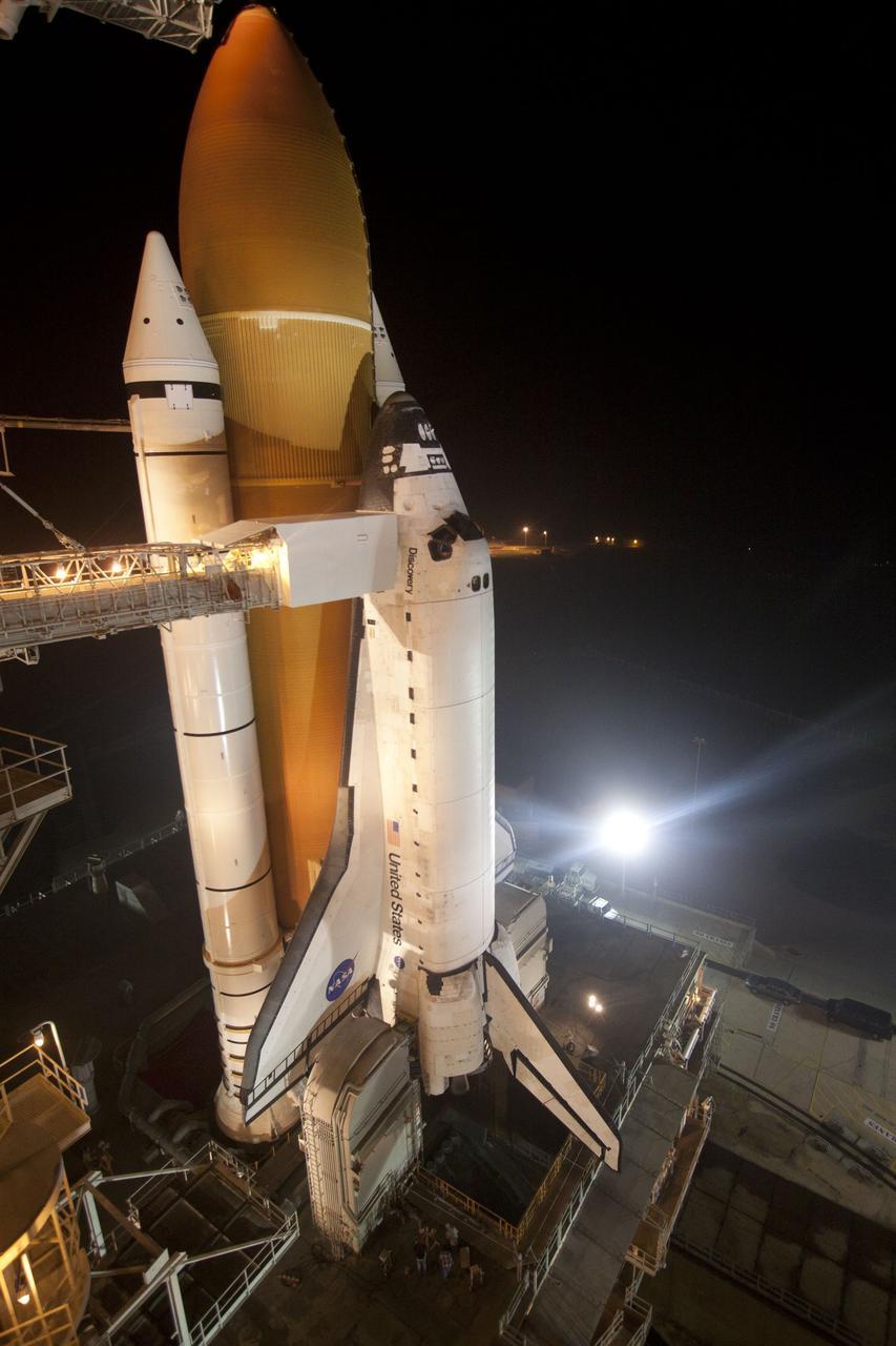 CAPE CANAVERAL, Fla. -- At NASA's Kennedy Space Center in Florida, space shuttle Discovery is illuminated by bright xenon lights on Launch Pad 39A after the rotating service structure was moved away. The structure provides weather protection and access to the shuttle while it awaits lift off on the pad. RSS "rollback," as it's called, began at 8:02 p.m. EST on Feb. 23 and wrapped up at 8:37 p.m. Scheduled to lift off Feb. 24 at 4:50 p.m. EST, Discovery and its six-member crew will deliver the Permanent Multipurpose Module, packed with supplies and critical spare parts, as well as Robonaut 2, the dexterous humanoid astronaut helper, to the International Space Station. Discovery, which will fly its 39th mission, is scheduled to be retired following STS-133. This will be the 133rd Space Shuttle Program mission and the 35th shuttle voyage to the space station. For more information on the STS-133 mission, visit www.nasa.gov/mission_pages/shuttle/shuttlemissions/sts133/. Photo credit: NASA/Jack Pfaller