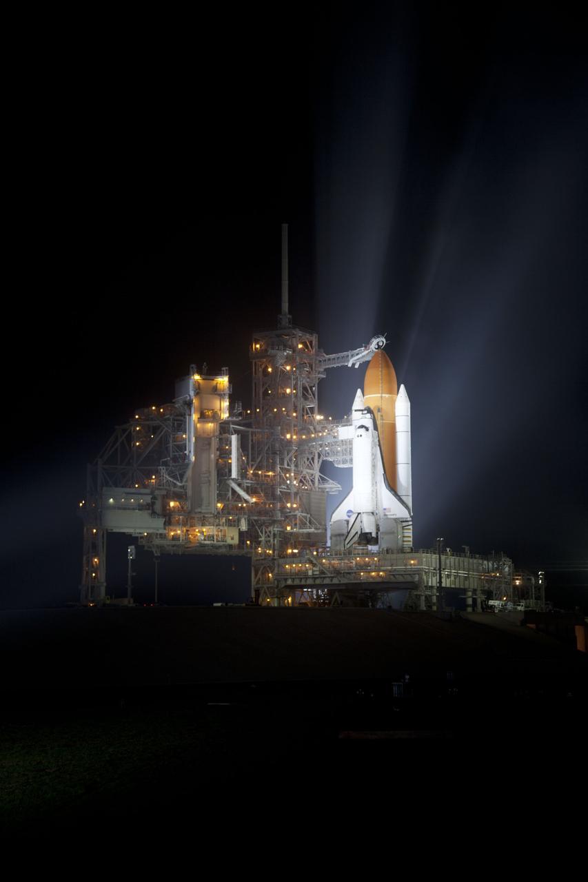 CAPE CANAVERAL, Fla. -- At NASA's Kennedy Space Center in Florida, space shuttle Discovery is illuminated by bright xenon lights on Launch Pad 39A after the rotating service structure was moved away. The structure provides weather protection and access to the shuttle while it awaits lift off on the pad. RSS "rollback," as it's called, began at 8:02 p.m. EST on Feb. 23 and wrapped up at 8:37 p.m. Scheduled to lift off Feb. 24 at 4:50 p.m. EST, Discovery and its six-member crew will deliver the Permanent Multipurpose Module, packed with supplies and critical spare parts, as well as Robonaut 2, the dexterous humanoid astronaut helper, to the International Space Station. Discovery, which will fly its 39th mission, is scheduled to be retired following STS-133. This will be the 133rd Space Shuttle Program mission and the 35th shuttle voyage to the space station. For more information on the STS-133 mission, visit www.nasa.gov/mission_pages/shuttle/shuttlemissions/sts133/. Photo credit: NASA/Frankie Martin