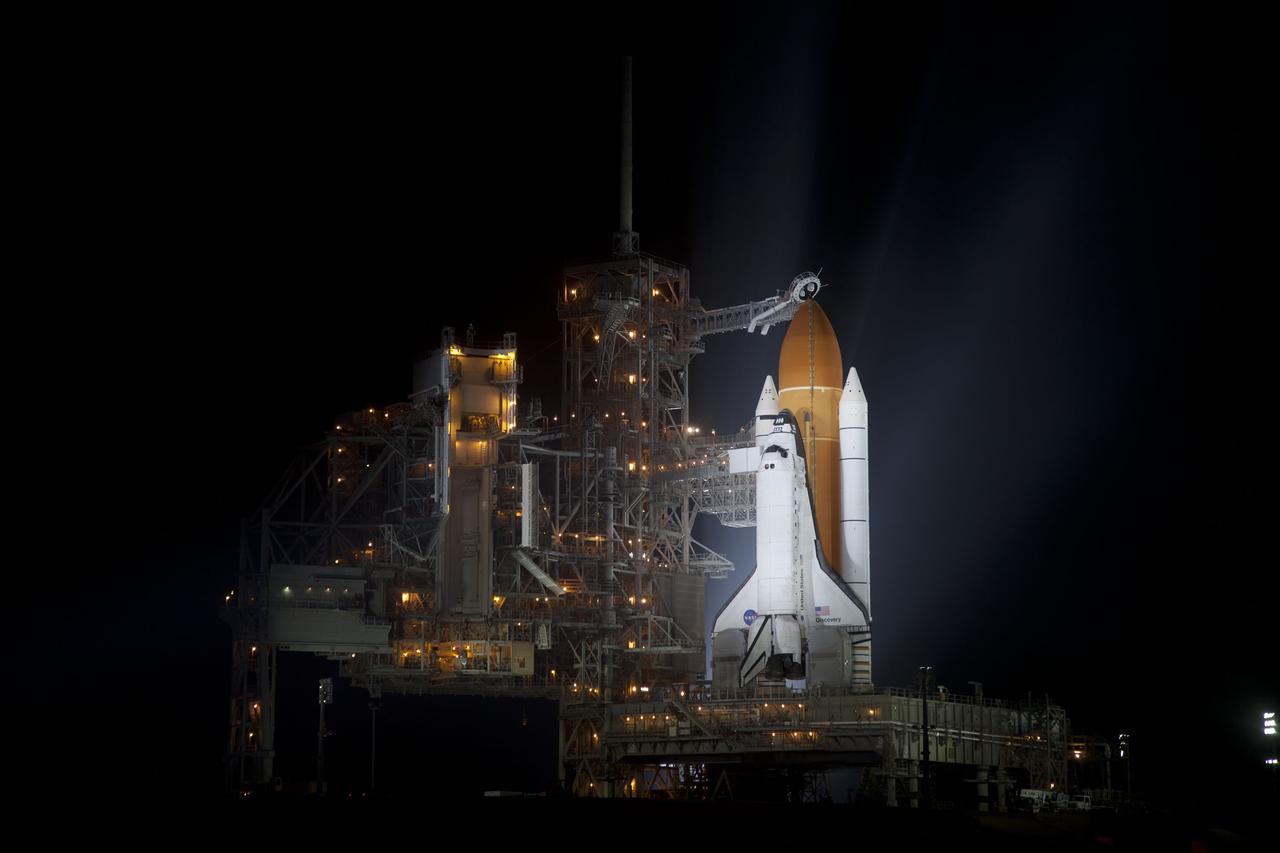 CAPE CANAVERAL, Fla. -- At NASA's Kennedy Space Center in Florida, space shuttle Discovery is illuminated by bright xenon lights on Launch Pad 39A after the rotating service structure was moved away. The structure provides weather protection and access to the shuttle while it awaits lift off on the pad. RSS "rollback," as it's called, began at 8:02 p.m. EST on Feb. 23 and wrapped up at 8:37 p.m. Scheduled to lift off Feb. 24 at 4:50 p.m. EST, Discovery and its six-member crew will deliver the Permanent Multipurpose Module, packed with supplies and critical spare parts, as well as Robonaut 2, the dexterous humanoid astronaut helper, to the International Space Station. Discovery, which will fly its 39th mission, is scheduled to be retired following STS-133. This will be the 133rd Space Shuttle Program mission and the 35th shuttle voyage to the space station. For more information on the STS-133 mission, visit www.nasa.gov/mission_pages/shuttle/shuttlemissions/sts133/. Photo credit: NASA/Frankie Martin