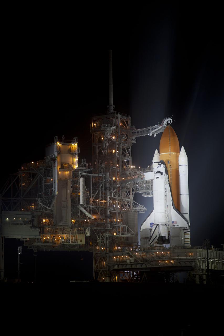 CAPE CANAVERAL, Fla. -- At NASA's Kennedy Space Center in Florida, space shuttle Discovery is illuminated by bright xenon lights on Launch Pad 39A after the rotating service structure was moved away. The structure provides weather protection and access to the shuttle while it awaits lift off on the pad. RSS "rollback," as it's called, began at 8:02 p.m. EST on Feb. 23 and wrapped up at 8:37 p.m. Scheduled to lift off Feb. 24 at 4:50 p.m. EST, Discovery and its six-member crew will deliver the Permanent Multipurpose Module, packed with supplies and critical spare parts, as well as Robonaut 2, the dexterous humanoid astronaut helper, to the International Space Station. Discovery, which will fly its 39th mission, is scheduled to be retired following STS-133. This will be the 133rd Space Shuttle Program mission and the 35th shuttle voyage to the space station. For more information on the STS-133 mission, visit www.nasa.gov/mission_pages/shuttle/shuttlemissions/sts133/. Photo credit: NASA/Frankie Martin