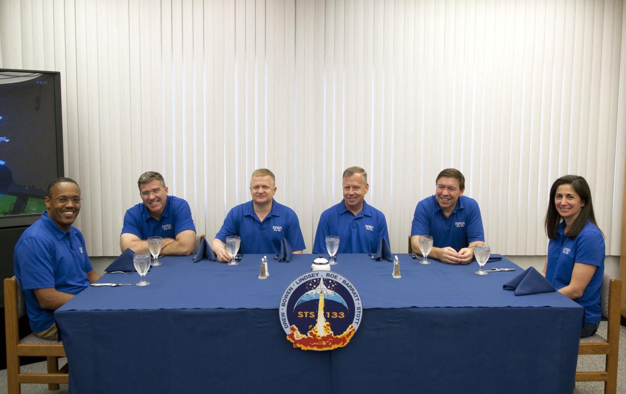 CAPE CANAVERAL, Fla. -- Space shuttle Discovery's six STS-133 astronauts sit down to eat breakfast together in their Astronaut Crew Quarters located in NASA Kennedy Space Center's Operations and Checkout Building (O&C). From left, are Mission Specialists Alvin Drew and Steve Bowen, Pilot Eric Boe, Commander Steve Lindsey, and Mission Specialists Michael Barratt and Nicole Stott. The crew woke up at about 7 a.m. to begin final preparations before their scheduled launch at 4:50 p.m. EST on Feb. 24. Discovery and its six-member crew will deliver the Permanent Multipurpose Module, packed with supplies and critical spare parts, as well as Robonaut 2, the dexterous humanoid astronaut helper, to the International Space Station. Discovery, which will fly its 39th mission, is scheduled to be retired following STS-133. This will be the 133rd Space Shuttle Program mission and the 35th shuttle voyage to the space station. For more information on the STS-133 mission, visit www.nasa.gov/mission_pages/shuttle/shuttlemissions/sts133/. Photo credit: NASA/Jim Grossmann
