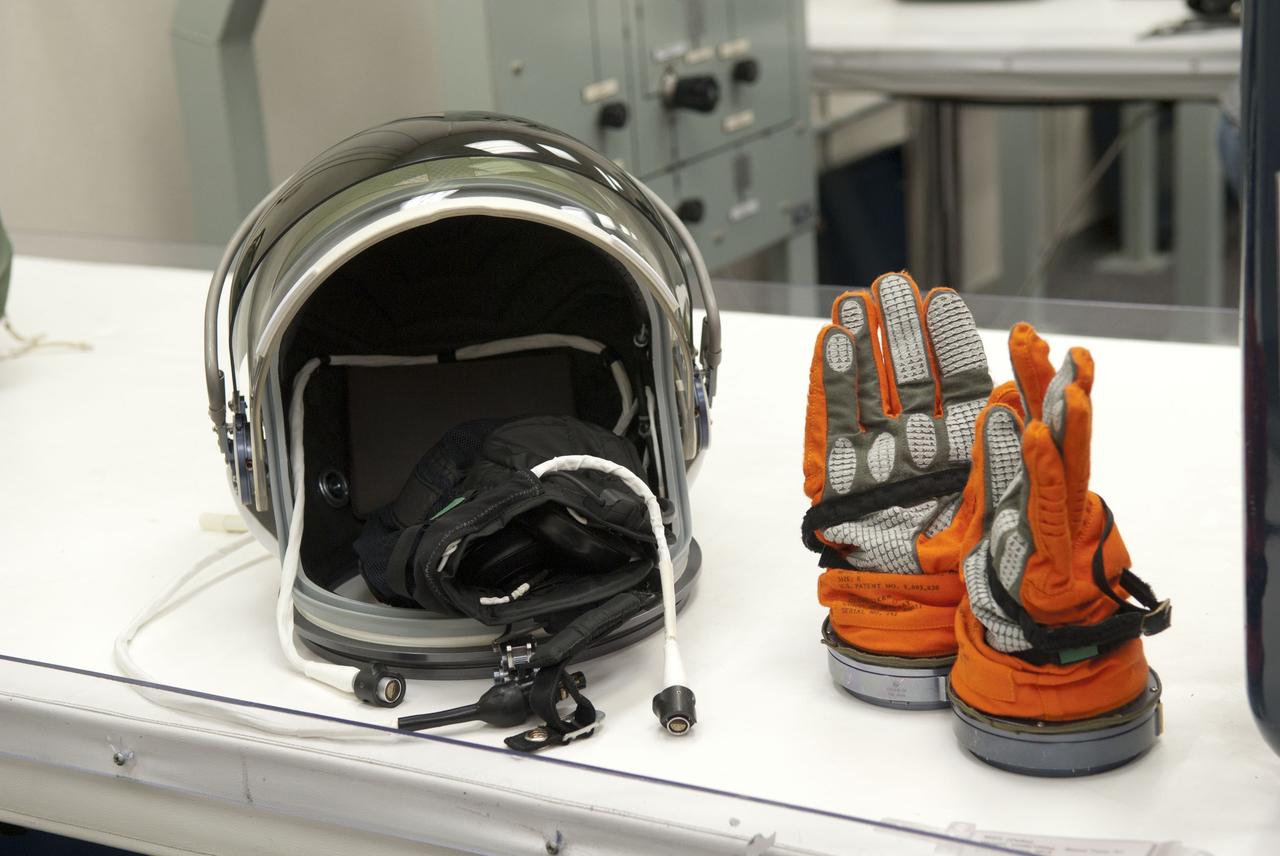 CAPE CANAVERAL, Fla. -- Inside the Operations and Checkout Building (O&C) at NASA's Kennedy Space Center in Florida, a helmet and gloves are ready to be worn by a member of the STS-133 crew during the climb into orbit aboard space shuttle Discovery. Scheduled to lift off Feb. 24 at 4:50 p.m. EST, Discovery and its crew will deliver the Permanent Multipurpose Module, packed with supplies and critical spare parts, as well as Robonaut 2, the dexterous humanoid astronaut helper, to the International Space Station. Discovery, which will fly its 39th mission, is scheduled to be retired following STS-133. This will be the 133rd Space Shuttle Program mission and the 35th shuttle voyage to the space station. For more information on the STS-133 mission, visit www.nasa.gov/mission_pages/shuttle/shuttlemissions/sts133/. Photo credit: NASA/Jim Grossmann