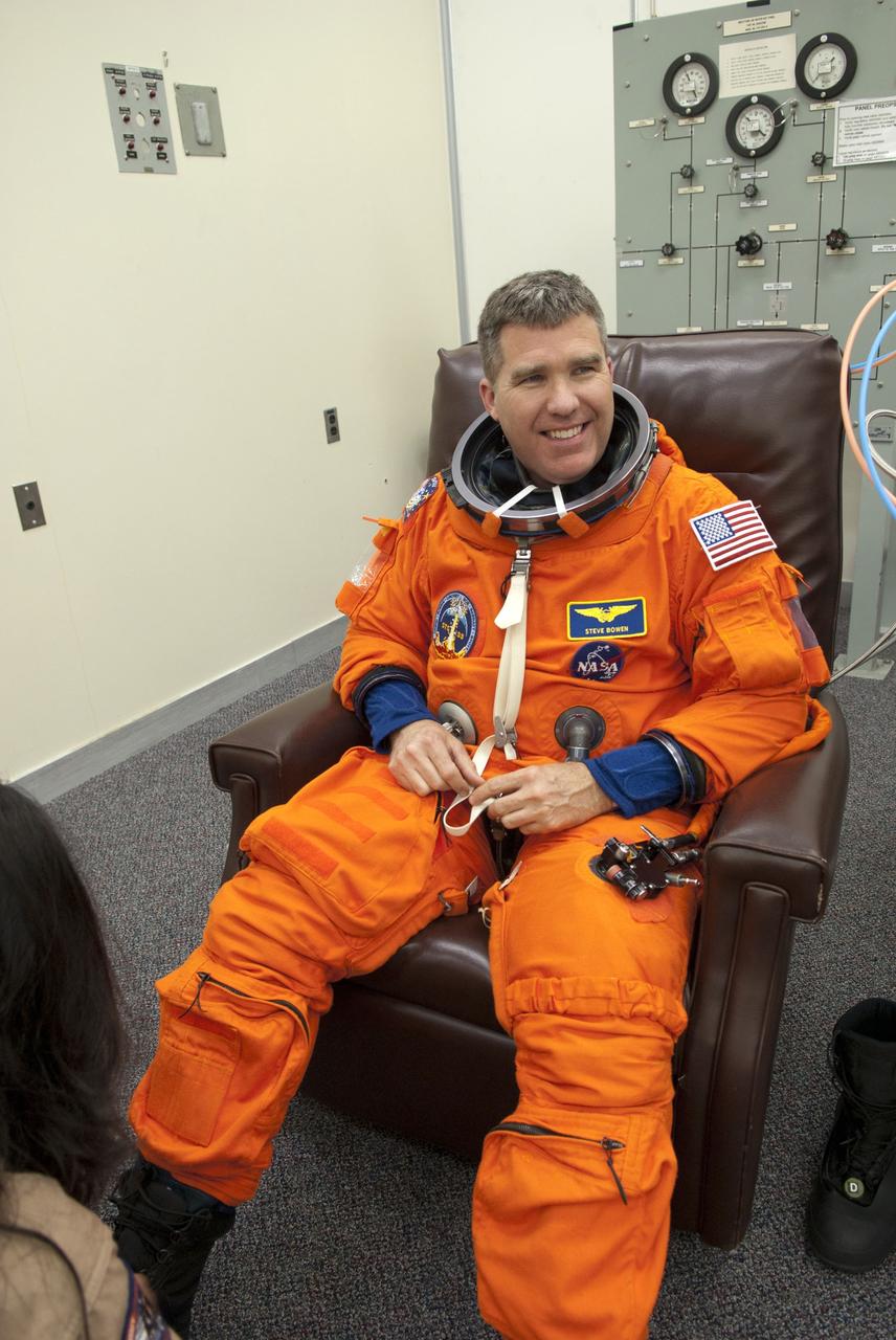 CAPE CANAVERAL, Fla. - In the Operations and Checkout Building (O&C) at NASA's Kennedy Space Center in Florida, the astronauts of space shuttle Discovery's STS-133 crew put on their launch-and-entry suits and check the fit of their helmets and gloves before heading to the Astrovan for the ride to Launch Pad 39A. Mission Specialist Steve Bowen, seen here, is making his third spaceflight. The last time he suited up for flight was in May 2010 for the STS-132 mission. Bowen replaces astronaut Tim Kopra as Mission Specialist 2, because Kopra was injured in a recent bicycle accident that prevented him from lifting off during this launch window. Scheduled to lift off Feb. 24 at 4:50 p.m. EST, Discovery and its crew will deliver the Permanent Multipurpose Module, packed with supplies and critical spare parts, as well as Robonaut 2, the dexterous humanoid astronaut helper, to the International Space Station. Discovery, which will fly its 39th mission, is scheduled to be retired following STS-133. This will be the 133rd Space Shuttle Program mission and the 35th shuttle voyage to the space station. For more information on the STS-133 mission, visit www.nasa.gov/mission_pages/shuttle/shuttlemissions/sts133/. Photo credit: NASA/Jim Grossmann