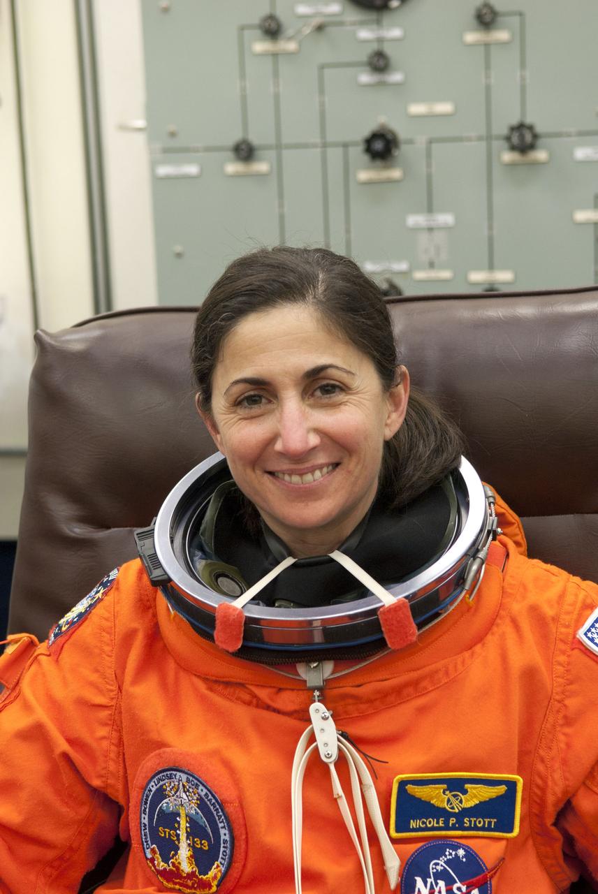 CAPE CANAVERAL, Fla. - In the Operations and Checkout Building (O&C) at NASA's Kennedy Space Center in Florida, the astronauts of space shuttle Discovery's STS-133 crew put on their launch-and-entry suits and check the fit of their helmets and gloves before heading to the Astrovan for the ride to Launch Pad 39A. Mission Specialist Nicole Stott, seen here, spent 91 days aboard the International Space Station in 2009 as a crew member of Expeditions 20 and 21. Scheduled to lift off Feb. 24 at 4:50 p.m. EST, Discovery and its crew will deliver the Permanent Multipurpose Module, packed with supplies and critical spare parts, as well as Robonaut 2, the dexterous humanoid astronaut helper, to the International Space Station. Discovery, which will fly its 39th mission, is scheduled to be retired following STS-133. This will be the 133rd Space Shuttle Program mission and the 35th shuttle voyage to the space station. For more information on the STS-133 mission, visit www.nasa.gov/mission_pages/shuttle/shuttlemissions/sts133/. Photo credit: NASA/Jim Grossmann