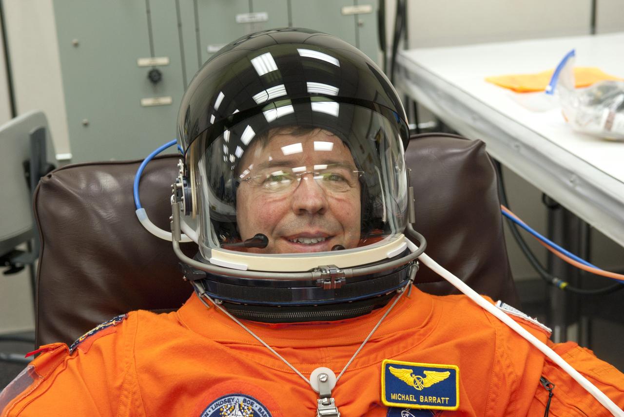 CAPE CANAVERAL, Fla. - In the Operations and Checkout Building (O&C) at NASA's Kennedy Space Center in Florida, the astronauts of space shuttle Discovery's STS-133 crew put on their launch-and-entry suits and check the fit of their helmets and gloves before heading to the Astrovan for the ride to Launch Pad 39A. Mission Specialist Michael Barratt, seen here, is making his first flight aboard a space shuttle. Barratt has called the space station home before, though, after spending 199 days as a crew member of Expeditions 19 and 20 in 2009. Scheduled to lift off Feb. 24 at 4:50 p.m. EST, Discovery and its crew will deliver the Permanent Multipurpose Module, packed with supplies and critical spare parts, as well as Robonaut 2, the dexterous humanoid astronaut helper, to the International Space Station. Discovery, which will fly its 39th mission, is scheduled to be retired following STS-133. This will be the 133rd Space Shuttle Program mission and the 35th shuttle voyage to the space station. For more information on the STS-133 mission, visit www.nasa.gov/mission_pages/shuttle/shuttlemissions/sts133/. Photo credit: NASA/Jim Grossmann