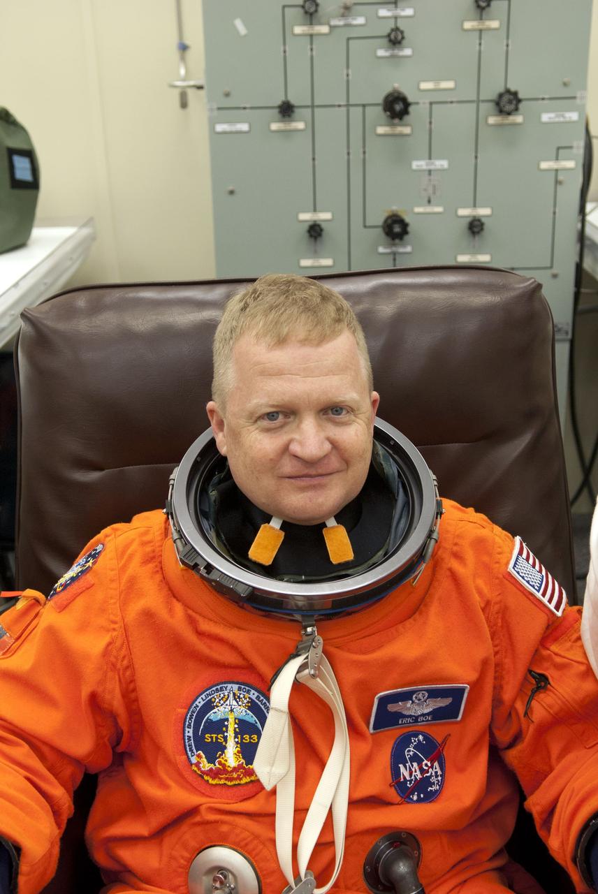 CAPE CANAVERAL, Fla. - In the Operations and Checkout Building (O&C) at NASA's Kennedy Space Center in Florida, the astronauts of space shuttle Discovery's STS-133 crew put on their launch-and-entry suits and check the fit of their helmets and gloves before heading to the Astrovan for the ride to Launch Pad 39A. Pilot Eric Boe, seen here, last piloted space shuttle Endeavour during its STS-126 mission back in 2008. Scheduled to lift off Feb. 24 at 4:50 p.m. EST, Discovery and its crew will deliver the Permanent Multipurpose Module, packed with supplies and critical spare parts, as well as Robonaut 2, the dexterous humanoid astronaut helper, to the International Space Station. Discovery, which will fly its 39th mission, is scheduled to be retired following STS-133. This will be the 133rd Space Shuttle Program mission and the 35th shuttle voyage to the space station. For more information on the STS-133 mission, visit www.nasa.gov/mission_pages/shuttle/shuttlemissions/sts133/. Photo credit: NASA/Jim Grossmann