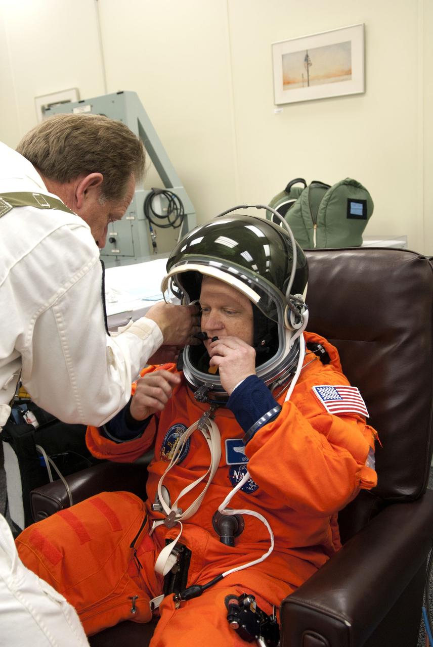 CAPE CANAVERAL, Fla. - In the Operations and Checkout Building (O&C) at NASA's Kennedy Space Center in Florida, the astronauts of space shuttle Discovery's STS-133 crew put on their launch-and-entry suits and check the fit of their helmets and gloves before heading to the Astrovan for the ride to Launch Pad 39A. Pilot Eric Boe, seen here, last piloted space shuttle Endeavour during its STS-126 mission back in 2008. Scheduled to lift off Feb. 24 at 4:50 p.m. EST, Discovery and its crew will deliver the Permanent Multipurpose Module, packed with supplies and critical spare parts, as well as Robonaut 2, the dexterous humanoid astronaut helper, to the International Space Station. Discovery, which will fly its 39th mission, is scheduled to be retired following STS-133. This will be the 133rd Space Shuttle Program mission and the 35th shuttle voyage to the space station. For more information on the STS-133 mission, visit www.nasa.gov/mission_pages/shuttle/shuttlemissions/sts133/. Photo credit: NASA/Jim Grossmann