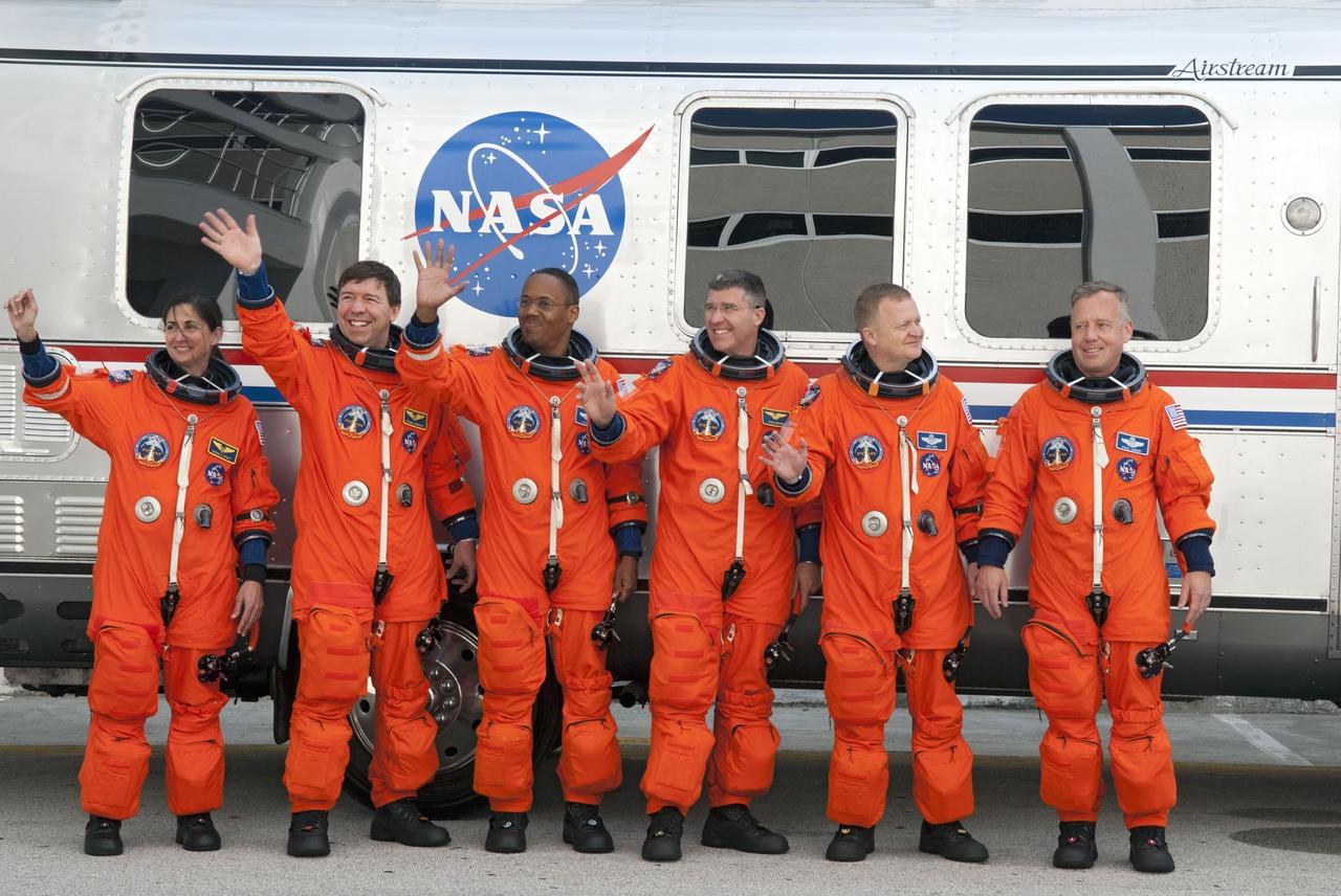 CAPE CANAVERAL, Fla. -- At the Operations and Checkout Building at NASA's Kennedy Space Center in Florida, space shuttle Discovery's STS-133 astronauts, dressed in their orange launch-and-entry suits, pause for a group portrait in front of the Astrovan which will transport them to Launch Pad 39A. From left are Mission Specialists Nicole Stott, Michael Barratt, Alvin Drew and Steve Bowen; Pilot Eric Boe; and Commander Steve Lindsey. Discovery and its six-member crew will deliver the Permanent Multipurpose Module, packed with supplies and critical spare parts, as well as Robonaut 2, the dexterous humanoid astronaut helper, to the International Space Station. Discovery, which will fly its 39th mission, is scheduled to be retired following STS-133. This will be the 133rd Space Shuttle Program mission and the 35th shuttle voyage to the space station. For more information on the STS-133 mission, visit www.nasa.gov/mission_pages/shuttle/shuttlemissions/sts133/. Photo credit: NASA/Jim Grossmann