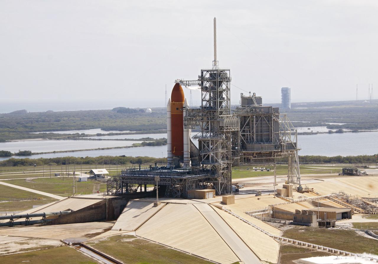 CAPE CANAVERAL, Fla. -- On Launch Pad 39A at NASA's Kennedy Space Center in Florida, space shuttle Discovery awaits the liftoff of its final scheduled mission on what is shaping up to be a picturesque day.    Liftoff is set for 4:50 p.m. EST on Feb. 24. Discovery and its six-member STS-133 crew will deliver the Permanent Multipurpose Module, packed with supplies and critical spare parts, as well as Robonaut 2, the dexterous humanoid astronaut helper, to the International Space Station. Discovery, which will fly its 39th mission, is scheduled to be retired following STS-133. This will be the 133rd Space Shuttle Program mission and the 35th shuttle voyage to the space station. For more information on the STS-133 mission, visit www.nasa.gov/mission_pages/shuttle/shuttlemissions/sts133/. Photo credit: NASA/Jack Pfaller