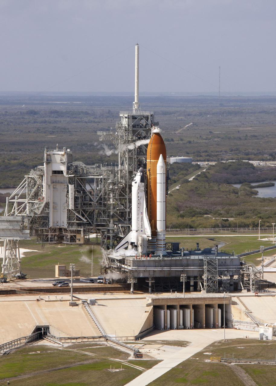 CAPE CANAVERAL, Fla. -- On Launch Pad 39A at NASA's Kennedy Space Center in Florida, space shuttle Discovery awaits the liftoff of its final scheduled mission on what is shaping up to be a picturesque day.    Liftoff is set for 4:50 p.m. EST on Feb. 24. Discovery and its six-member STS-133 crew will deliver the Permanent Multipurpose Module, packed with supplies and critical spare parts, as well as Robonaut 2, the dexterous humanoid astronaut helper, to the International Space Station. Discovery, which will fly its 39th mission, is scheduled to be retired following STS-133. This will be the 133rd Space Shuttle Program mission and the 35th shuttle voyage to the space station. For more information on the STS-133 mission, visit www.nasa.gov/mission_pages/shuttle/shuttlemissions/sts133/. Photo credit: NASA/Jack Pfaller