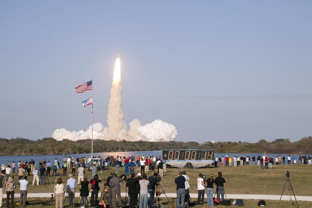 CAPE CANAVERAL, Fla. - Space shuttle Discovery's liftoff from Launch Pad 39A at NASA's Kennedy Space Center in Florida on a picturesque, warm, late February afternoon is witnessed by news media representatives near the countdown clock at the Press Site. Launch of the STS-133 mission was at 4:53 p.m. EST on Feb. 24. Discovery and its six-member crew are on a mission to deliver the Permanent Multipurpose Module, packed with supplies and critical spare parts, as well as Robonaut 2, the dexterous humanoid astronaut helper, to the International Space Station. Discovery is making its 39th mission and is scheduled to be retired following STS-133. This is the 133rd Space Shuttle Program mission and the 35th shuttle voyage to the space station. For more information on the STS-133 mission, visit www.nasa.gov/mission_pages/shuttle/shuttlemissions/sts133/. Photo credit: NASA/Troy Cryder