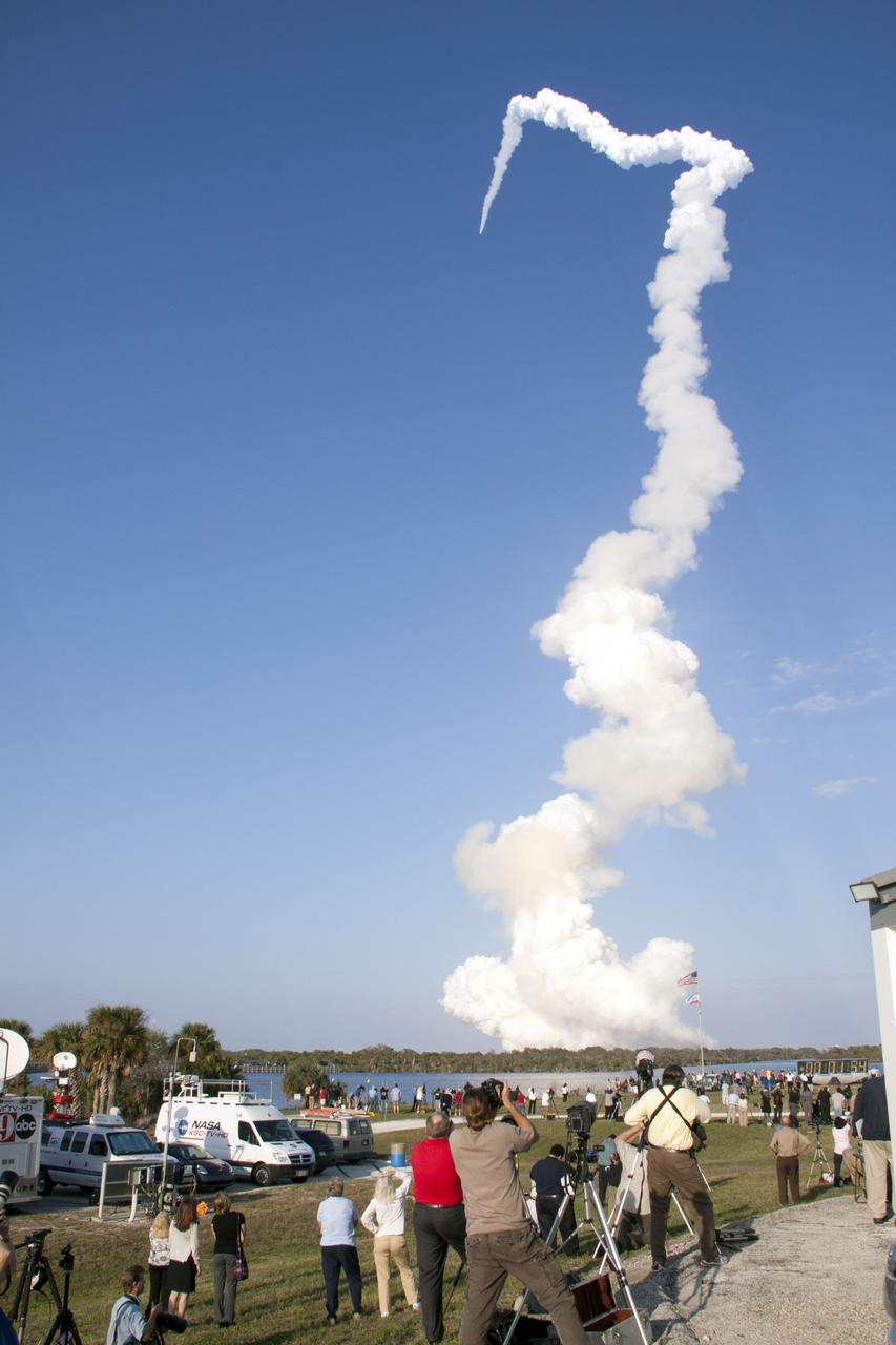 CAPE CANAVERAL, Fla. - Space shuttle Discovery's liftoff from Launch Pad 39A at NASA's Kennedy Space Center in Florida on a picturesque, warm, late February afternoon is witnessed by news media representatives near the countdown clock at the Press Site. Launch of the STS-133 mission was at 4:53 p.m. EST on Feb. 24.   Discovery and its six-member crew are on a mission to deliver the Permanent Multipurpose Module, packed with supplies and critical spare parts, as well as Robonaut 2, the dexterous humanoid astronaut helper, to the International Space Station. Discovery is making its 39th mission and is scheduled to be retired following STS-133. This is the 133rd Space Shuttle Program mission and the 35th shuttle voyage to the space station. For more information on the STS-133 mission, visit www.nasa.gov/mission_pages/shuttle/shuttlemissions/sts133/.  Photo credit: NASA/Troy Cryder