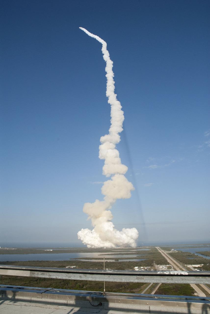 CAPE CANAVERAL, Fla. -- Taken from the roof of the Vehicle Assembly Building at NASA's Kennedy Space Center in Florida, space shuttle Discovery lifts off Launch Pad 39A atop twin columns of fire, creating rolling clouds of smoke and steam in its track. Launch of the STS-133 mission was at 4:53 p.m. EST on Feb. 24.           Discovery and its six-member crew are on a mission to deliver the Permanent Multipurpose Module, packed with supplies and critical spare parts, as well as Robonaut 2, the dexterous humanoid astronaut helper, to the International Space Station. Discovery is making its 39th mission and is scheduled to be retired following STS-133. This is the 133rd Space Shuttle Program mission, the 35th shuttle voyage to the space station and Discovery's final mission. For more information on the STS-133 mission, visit www.nasa.gov/mission_pages/shuttle/shuttlemissions/sts133/. Photo credit: NASA/Jeff Marino