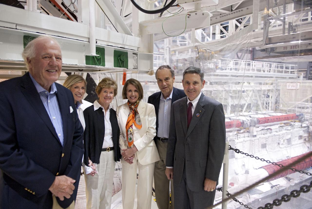 CAPE CANAVERAL, Fla. -- CAPE CANAVERAL, Fla. -- House Of Representatives Democratic Leader Nancy Pelosi, from California's 8th District, fourth from left, and other VIPs pose for a photo with NASA Kennedy Space Center Director Robert Cabana. They are at Florida's space center to witness space shuttle Discovery make history as it lifts off on its final scheduled mission from Launch Pad 39A. While at the center, they attended a presentation in the Operations Support Building II and toured Orbiter Processing Facilities 1 and 2 where shuttles Atlantis and Endeavour are being prepared for their final missions respectively.        Discovery and its six-member STS-133 crew will deliver the Permanent Multipurpose Module, packed with supplies and critical spare parts, as well as Robonaut 2, the dexterous humanoid astronaut helper, to the International Space Station. Discovery will make its 39th mission and is scheduled to be retired following STS-133. This will be the 133rd Space Shuttle Program mission and the 35th shuttle voyage to the space station. For more information on the STS-133 mission, visit www.nasa.gov/mission_pages/shuttle/shuttlemissions/sts133/.  Photo credit: NASA/Jim Grossmann