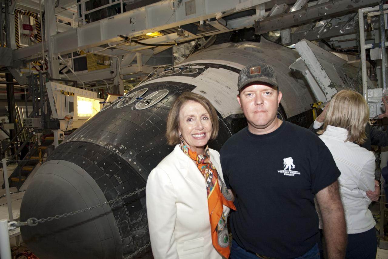 CAPE CANAVERAL, Fla. -- House Of Representatives Democratic Leader Nancy Pelosi, from California's 8th District, left, and United Space Alliance worker Brian Elleman pose for a photo at NASA's Kennedy Space Center in Florida. Pelosi is at the space center to witness space shuttle Discovery make history as it lifts off on its final scheduled mission from Launch Pad 39A. While at the center, Pelosi attended a presentation in the Operations Support Building II and toured Orbiter Processing Facilities 1 and 2 where shuttles Atlantis and Endeavour are being prepared for their final missions respectively. Discovery and its six-member STS-133 crew will deliver the Permanent Multipurpose Module, packed with supplies and critical spare parts, as well as Robonaut 2, the dexterous humanoid astronaut helper, to the International Space Station. Discovery will make its 39th mission and is scheduled to be retired following STS-133. This will be the 133rd Space Shuttle Program mission and the 35th shuttle voyage to the space station. For more information on the STS-133 mission, visit www.nasa.gov/mission_pages/shuttle/shuttlemissions/sts133/. Photo credit: NASA/Jim Grossmann