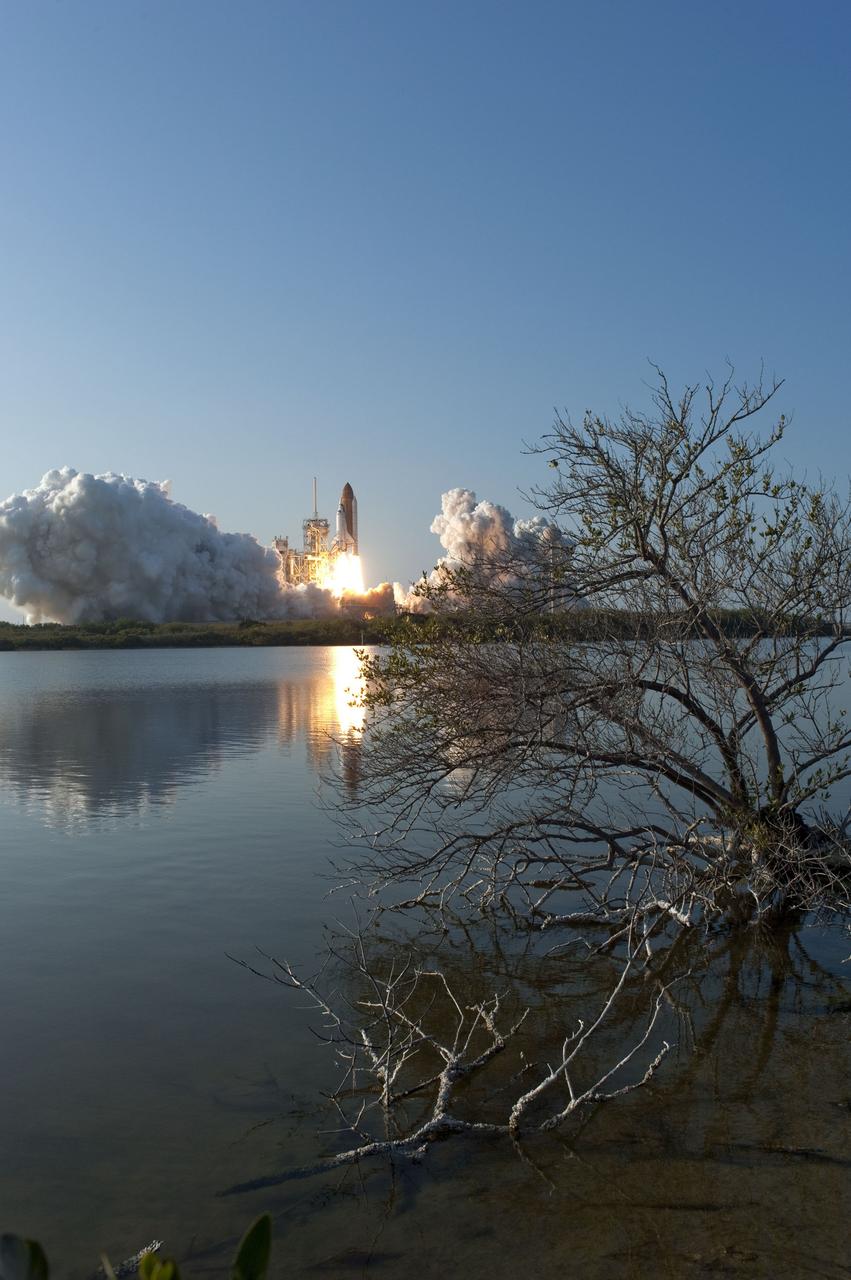 CAPE CANAVERAL, Fla. -- Space shuttle Discovery's liftoff is reflected in the water as it roars off Launch Pad 39A in a swirl of billowing smoke and steam at NASA's Kennedy Space Center in Florida to begin its final flight to the International Space Station on the STS-133 mission. Launch was at 4:53 p.m. EST.    Discovery and its six-member crew will deliver the Permanent Multipurpose Module, packed with supplies and critical spare parts, as well as Robonaut 2, the dexterous humanoid astronaut helper, to the orbiting outpost. Discovery is flying on its 39th mission and is scheduled to be retired following STS-133. This is the 133rd Space Shuttle Program mission and the 35th shuttle voyage to the space station. For more information on the STS-133 mission, visit www.nasa.gov/mission_pages/shuttle/shuttlemissions/sts133/. Photo credit: NASA/Sandra Joseph and Kevin O'Connell