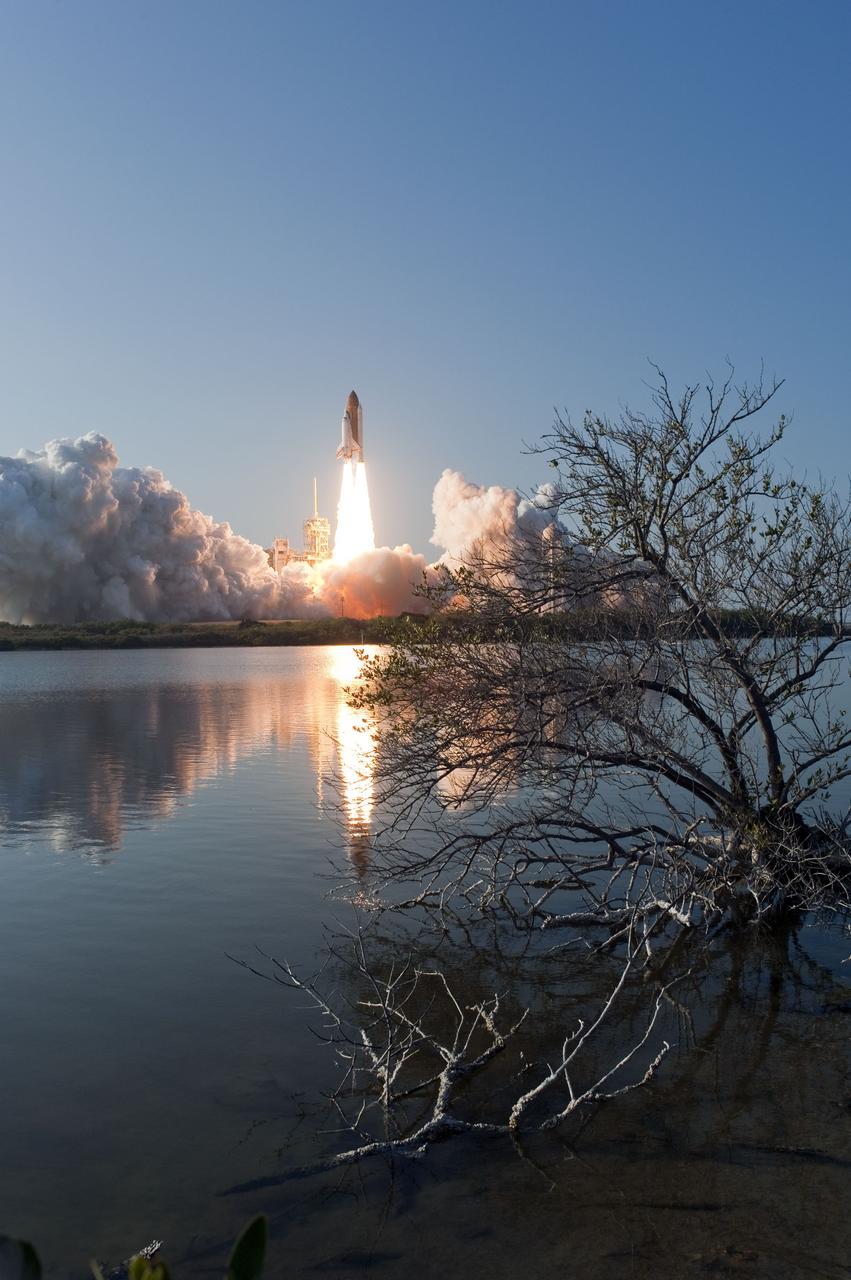 CAPE CANAVERAL, Fla. -- Space shuttle Discovery's liftoff is reflected in the water as it roars off Launch Pad 39A in a swirl of billowing smoke and steam at NASA's Kennedy Space Center in Florida to begin its final flight to the International Space Station on the STS-133 mission. Launch was at 4:53 p.m. EST.    Discovery and its six-member crew will deliver the Permanent Multipurpose Module, packed with supplies and critical spare parts, as well as Robonaut 2, the dexterous humanoid astronaut helper, to the orbiting outpost. Discovery is flying on its 39th mission and is scheduled to be retired following STS-133. This is the 133rd Space Shuttle Program mission and the 35th shuttle voyage to the space station. For more information on the STS-133 mission, visit www.nasa.gov/mission_pages/shuttle/shuttlemissions/sts133/. Photo credit: NASA/Sandra Joseph and Kevin O'Connell
