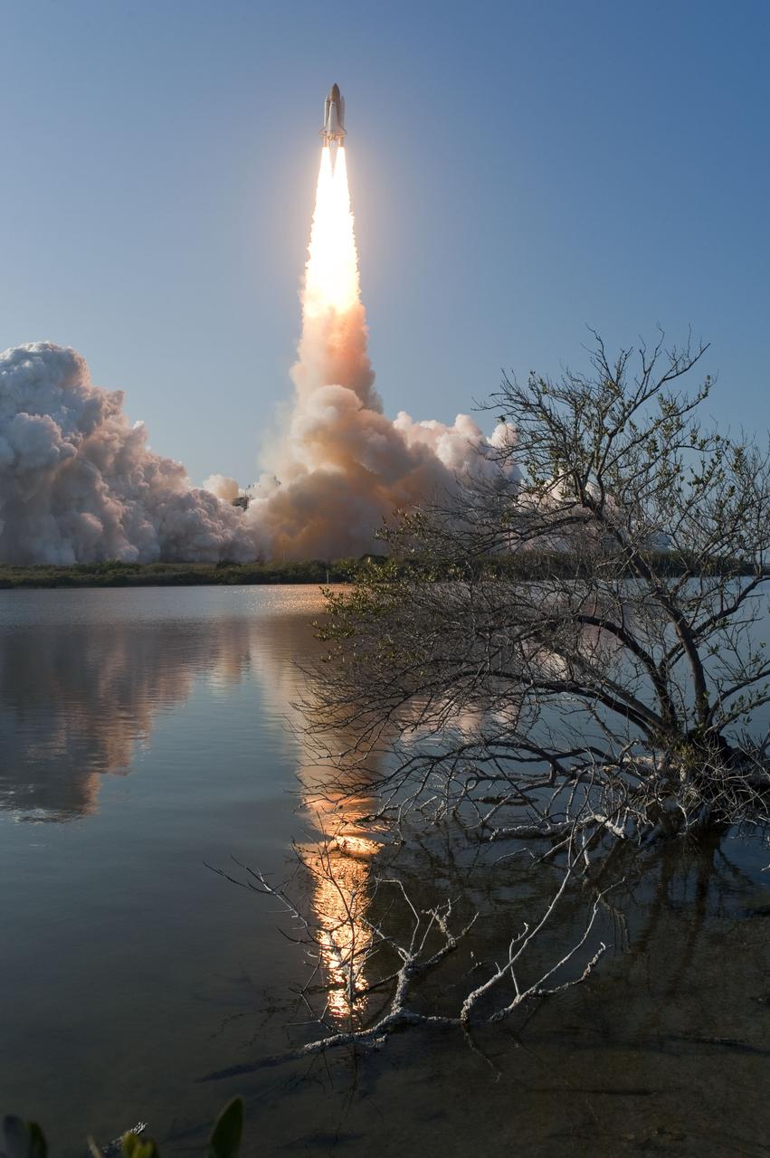 CAPE CANAVERAL, Fla. -- Space shuttle Discovery's liftoff is reflected in the water as it roars off Launch Pad 39A in a swirl of billowing smoke and steam at NASA's Kennedy Space Center in Florida to begin its final flight to the International Space Station on the STS-133 mission. Launch was at 4:53 p.m. EST.    Discovery and its six-member crew will deliver the Permanent Multipurpose Module, packed with supplies and critical spare parts, as well as Robonaut 2, the dexterous humanoid astronaut helper, to the orbiting outpost. Discovery is flying on its 39th mission and is scheduled to be retired following STS-133. This is the 133rd Space Shuttle Program mission and the 35th shuttle voyage to the space station. For more information on the STS-133 mission, visit www.nasa.gov/mission_pages/shuttle/shuttlemissions/sts133/. Photo credit: NASA/Sandra Joseph and Kevin O'Connell
