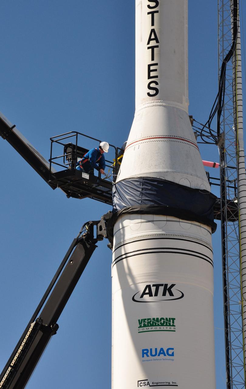 VANDENBERG AIR FORCE BASE, Calif. -- On Space Launch Complex 576-E at Vandenberg Air Force Base in California, workers enclose the spacecraft's fairing in a non-flight environmental shield that will be removed before launch. The Orbital Sciences Taurus XL rocket will launch Glory into low Earth orbit. Once Glory reaches orbit, it will collect data on the properties of aerosols and black carbon. It also will help scientists understand how the sun's irradiance affects Earth's climate. Launch is scheduled for 5:09 a.m. EST Feb. 23. For information, visit www.nasa.gov/glory. Photo credit: NASA/Randy Beaudoin, VAFB