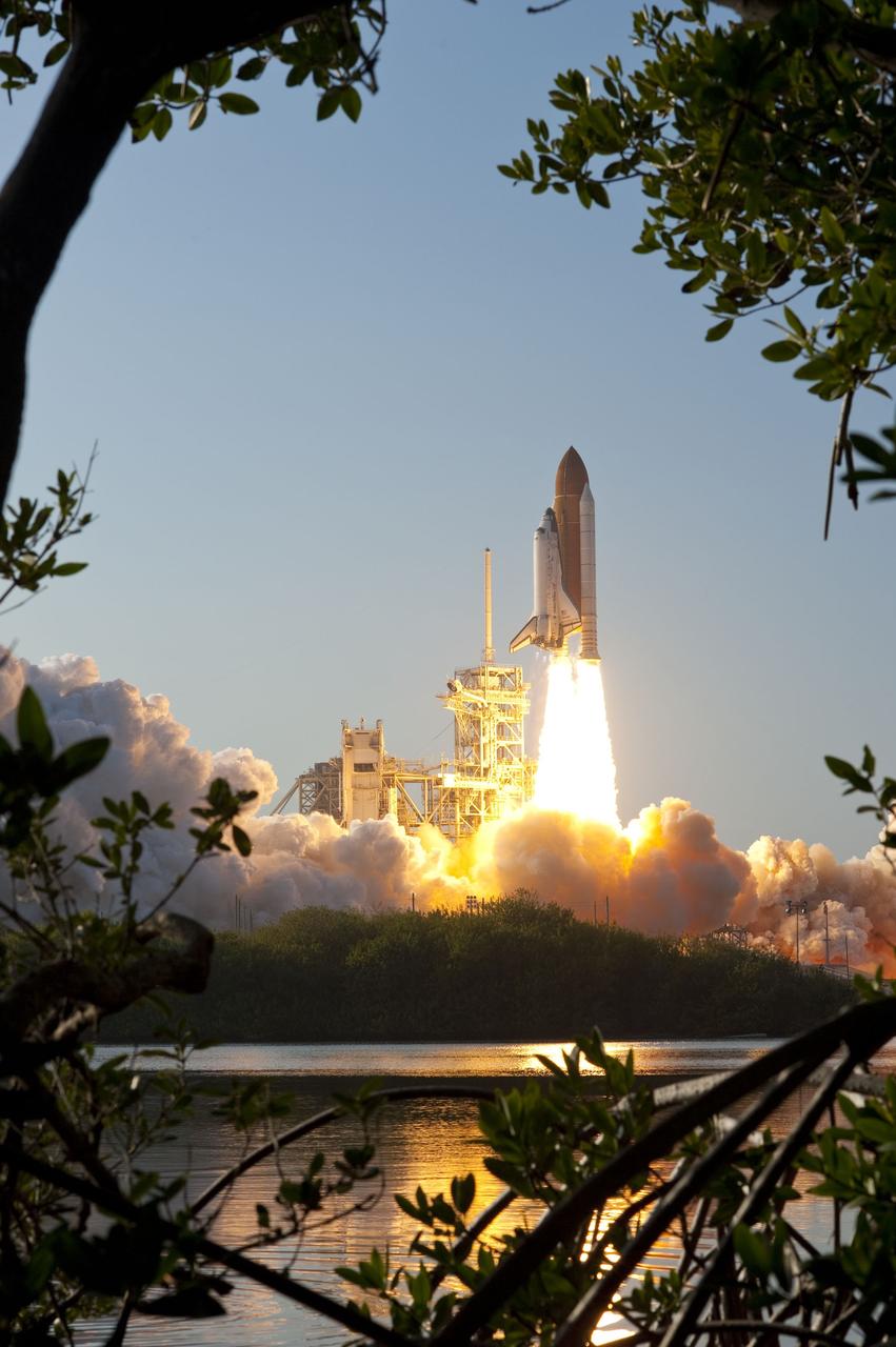 CAPE CANAVERAL, Fla. -- In a swirl of billowing smoke and steam, Space shuttle Discovery's liftoff is reflected in the water as it roars off Launch Pad 39A at NASA's Kennedy Space Center in Florida beginning its final flight to the International Space Station on the STS-133 mission. Launch was at 4:53 p.m. EST.          Discovery and its six-member crew will deliver the Permanent Multipurpose Module, packed with supplies and critical spare parts, as well as Robonaut 2, the dexterous humanoid astronaut helper, to the orbiting outpost. Discovery is flying on its 39th mission and is scheduled to be retired following STS-133. This is the 133rd Space Shuttle Program mission and the 35th shuttle voyage to the space station. For more information on the STS-133 mission, visit www.nasa.gov/mission_pages/shuttle/shuttlemissions/sts133/. Photo credit: NASA/Sandra Joseph and Kevin O'Connell