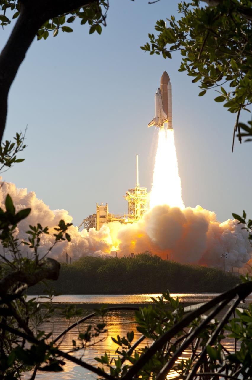 CAPE CANAVERAL, Fla. -- On pillars of fire, Space shuttle Discovery's liftoff is reflected in the water as it roars off Launch Pad 39A at NASA's Kennedy Space Center in Florida beginning its final flight to the International Space Station on the STS-133 mission. Launch was at 4:53 p.m. EST.        Discovery and its six-member crew will deliver the Permanent Multipurpose Module, packed with supplies and critical spare parts, as well as Robonaut 2, the dexterous humanoid astronaut helper, to the orbiting outpost. Discovery is flying on its 39th mission and is scheduled to be retired following STS-133. This is the 133rd Space Shuttle Program mission and the 35th shuttle voyage to the space station. For more information on the STS-133 mission, visit www.nasa.gov/mission_pages/shuttle/shuttlemissions/sts133/. Photo credit: NASA/Sandra Joseph and Kevin O'Connell
