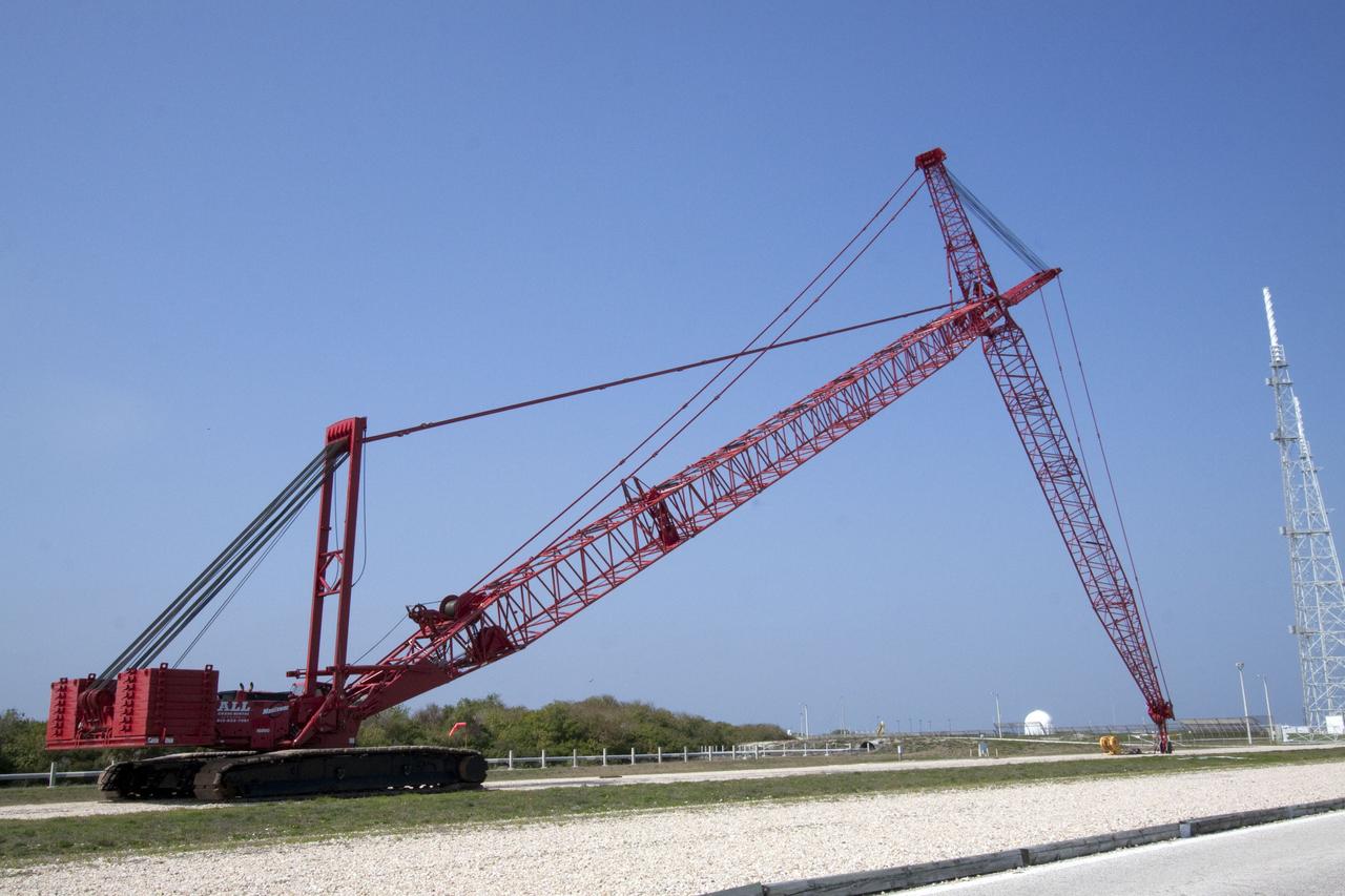 CAPE CANAVERAL, Fla. -- At NASA's Kennedy Space Center in Florida, a heavy-duty crane is slowly making its way to Launch Pad 39B, to continue deconstruction of the pad which is being restructured for future use. The new design will feature a "clean pad" for rockets to come with their own launcher, making it more versatile for a number of vehicles. For information on NASA's future plans, visit www.nasa.gov. Photo credit: NASA/Jack Pfaller