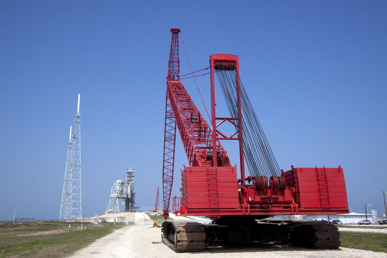 CAPE CANAVERAL, Fla. -- At NASA's Kennedy Space Center in Florida, a heavy-duty crane is slowly making its way to Launch Pad 39B, to continue deconstruction of the pad which is being restructured for future use. The new design will feature a "clean pad" for rockets to come with their own launcher, making it more versatile for a number of vehicles. For information on NASA's future plans, visit www.nasa.gov. Photo credit: NASA/Jack Pfaller