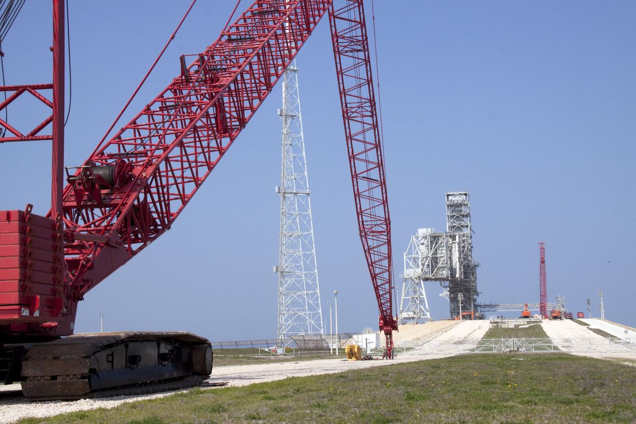 CAPE CANAVERAL, Fla. -- At NASA's Kennedy Space Center in Florida, a heavy-duty crane is slowly making its way to Launch Pad 39B, to continue deconstruction of the pad which is being restructured for future use. The new design will feature a "clean pad" for rockets to come with their own launcher, making it more versatile for a number of vehicles. For information on NASA's future plans, visit www.nasa.gov. Photo credit: NASA/Jack Pfaller
