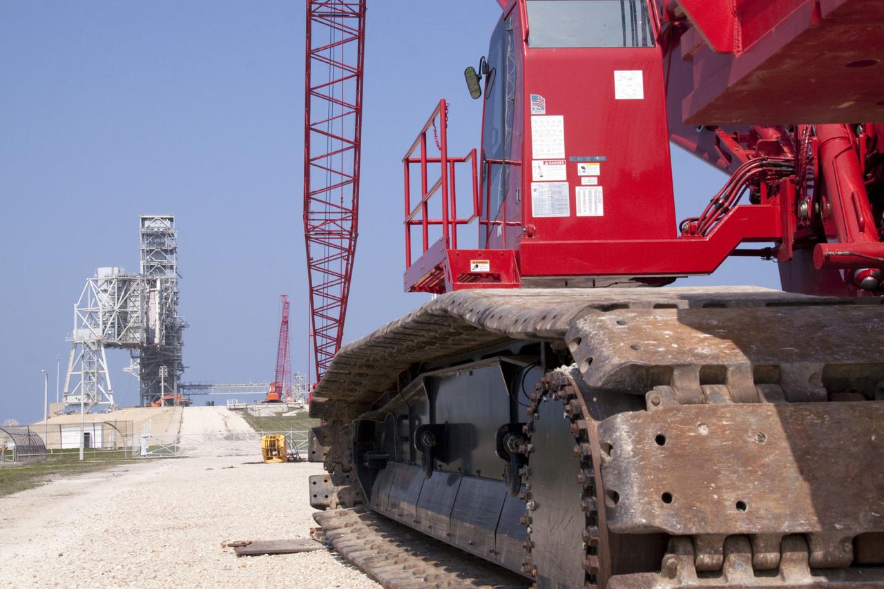 CAPE CANAVERAL, Fla. -- At NASA's Kennedy Space Center in Florida, a heavy-duty crane is slowly making its way to Launch Pad 39B, to continue deconstruction of the pad which is being restructured for future use. The new design will feature a "clean pad" for rockets to come with their own launcher, making it more versatile for a number of vehicles. For information on NASA's future plans, visit www.nasa.gov. Photo credit: NASA/Jack Pfaller