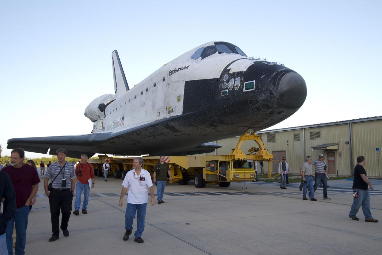 CAPE CANAVERAL, Fla. -- At NASA's Kennedy Space Center in Florida, workers accompany space shuttle Endeavour as it is being transported from Orbiter Processing Facility-2 to the Vehicle Assembly Building. Endeavour and its STS-134 crew will deliver the Express Logistics Carrier-3, Alpha Magnetic Spectrometer, spare parts, a high-pressure gas tank, additional spare parts for Dextre and micrometeoroid debris shields to the International Space Station. Launch is targeted for April 19 at 7:48 p.m. EDT. For more information visit, http://www.nasa.gov/mission_pages/shuttle/shuttlemissions/sts134/index.html. Photo credit: NASA/Jack Pfaller